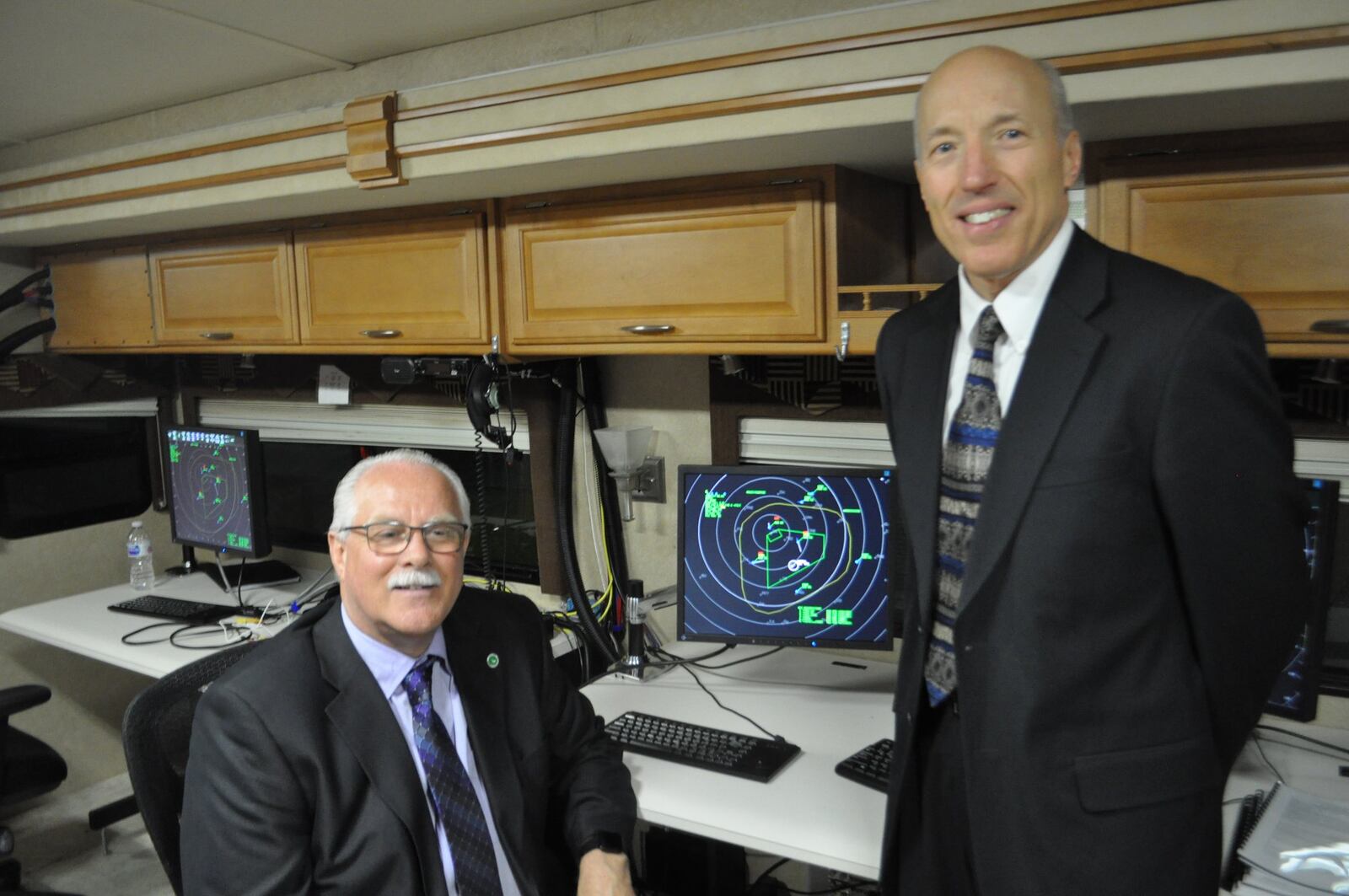 Richard Fox, operations manager for the Ohio UAS center and Art Huber, deputy director of operations for AFRL work in the SkyVision RV. The new $5-million RV acts as an air traffic control hub for drones.