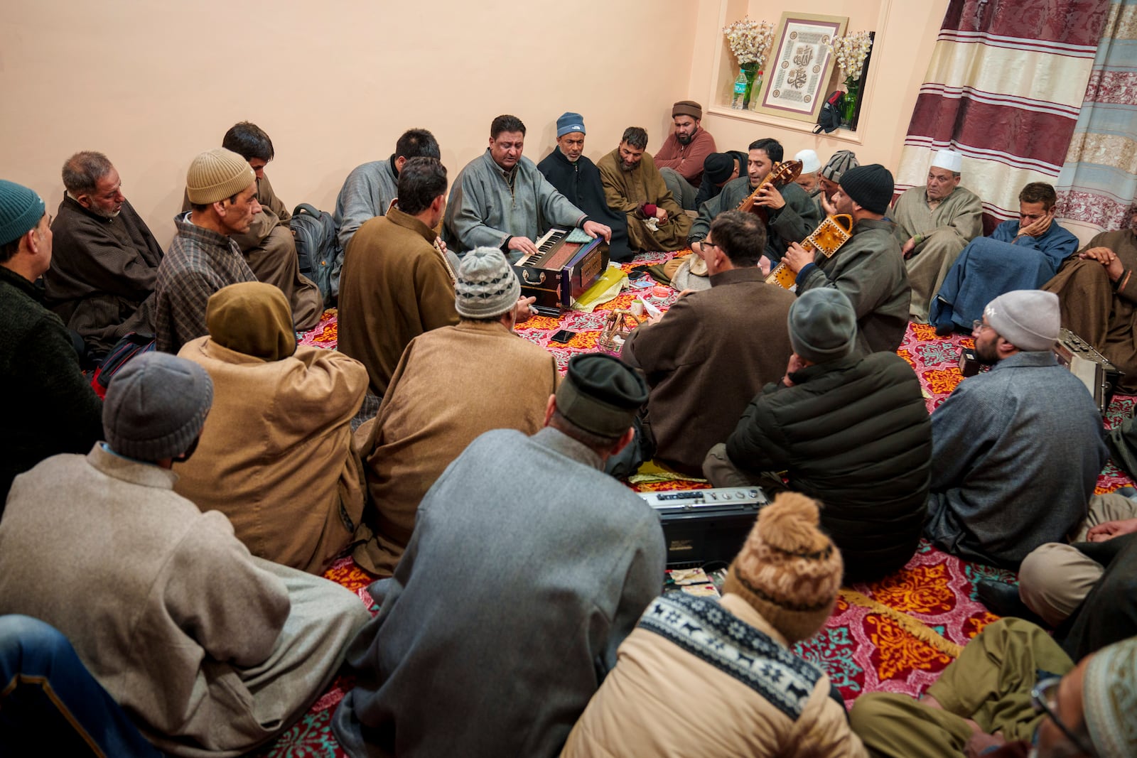 Kashmiri men listen as Sufi singers perform during a musical gathering in the outskirts of Srinagar, Indian controlled Kashmir, Thursday, Feb. 13, 2025. (AP Photo/Dar Yasin)