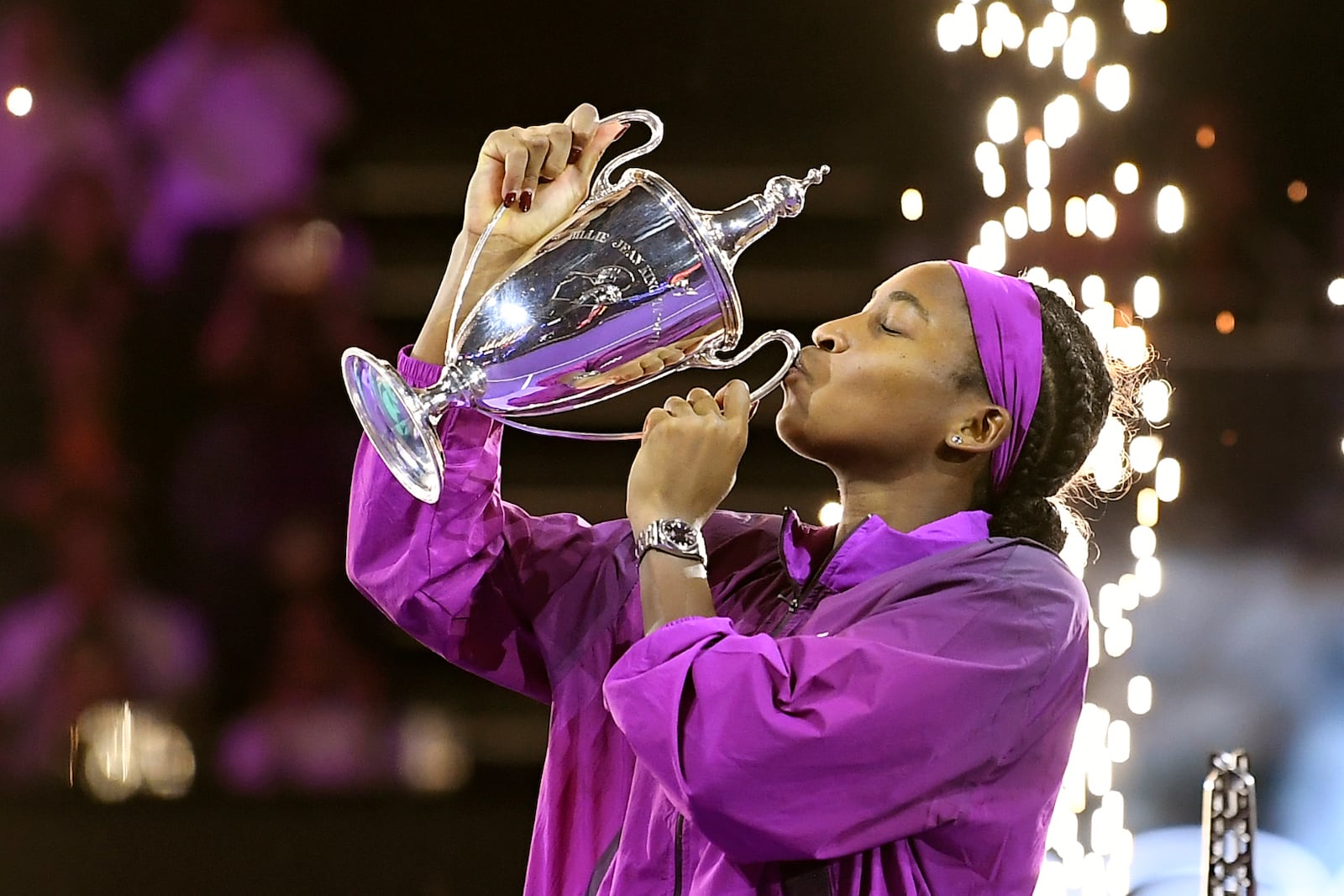 Coco Gauff of the U.S. kisses her trophy after winning against China's Qinwen Zheng in their women's singles final match of the WTA finals at the King Saud University Indoor Arena, in Riyadh, Saudi Arabia, Saturday, Nov. 9, 2024. (AP Photo)