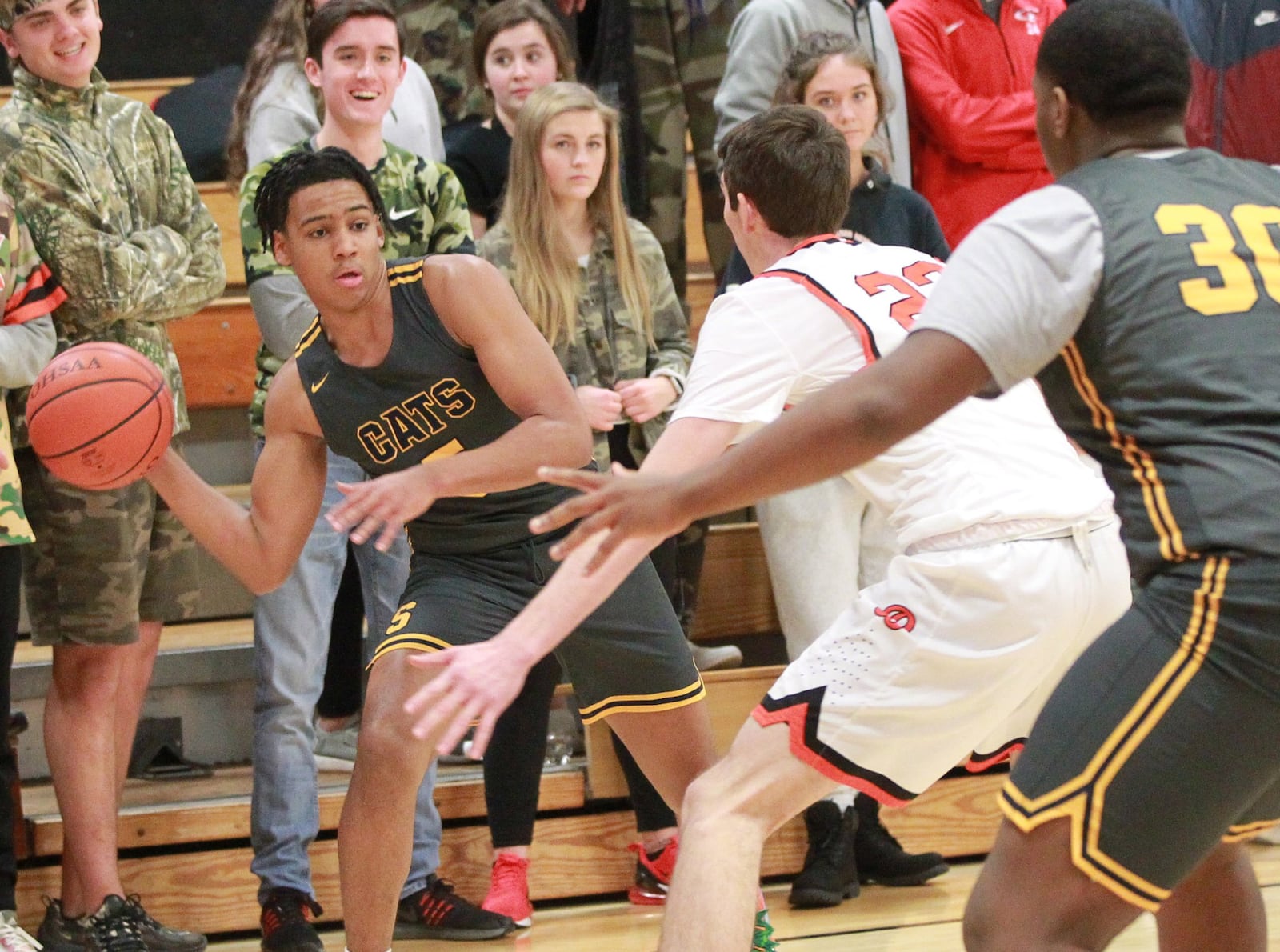 Josh Tolliver of Springfield (with ball) draws Beavercreek defender Braden Grant. Beavercreek defeated visiting Springfield 54-48 in a GWOC boys high school basketball game on Tuesday, Dec. 17, 2019. MARC PENDLETON / STAFF