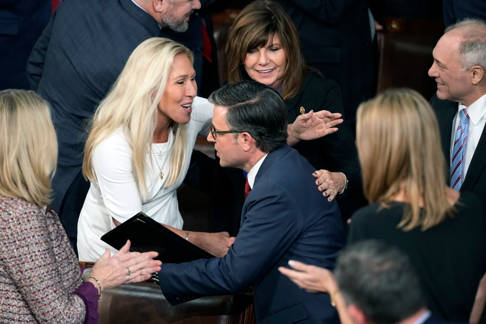 Speaker Mike Johnson, R-La., reenters the House Chamber after being re-elected Speaker as the House of Representatives convenes, and is greeted by Rep. Marjorie Taylor Greene, R-Ga., at the Capitol in Washington, Friday, Jan. 3, 2025. (AP Photo/J. Scott Applewhite)