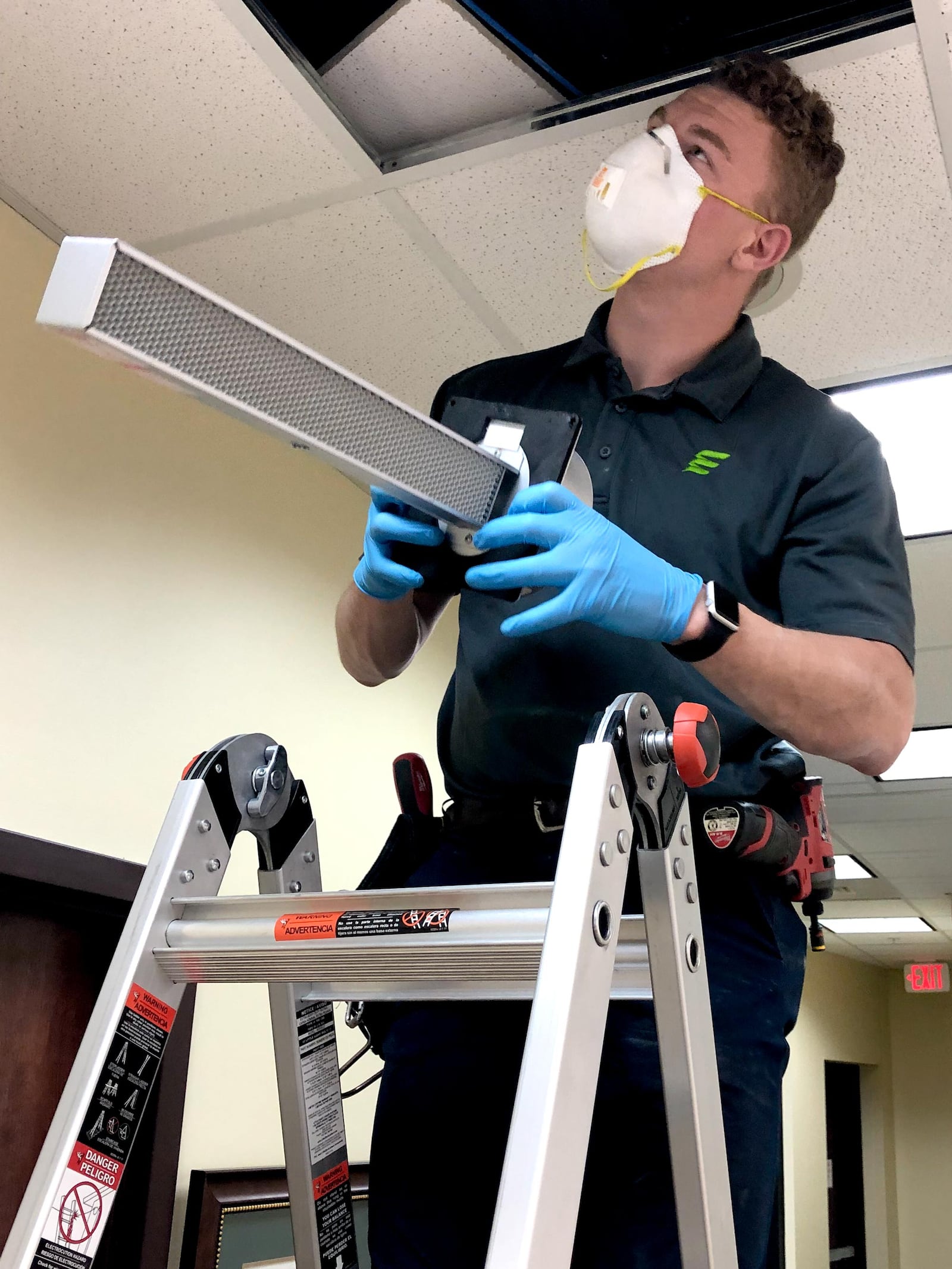 Robbie Mount of Extreme Microbial Technologies installs an air quality system which has the technology to help battle the coronavirus. STAFF