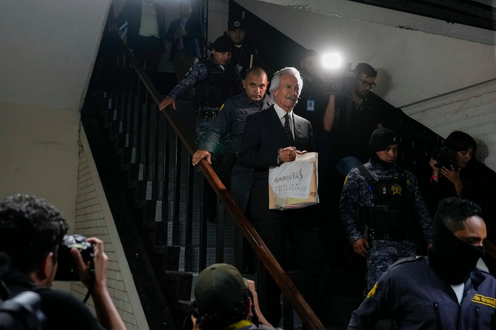 Guatemalan journalist Jose Ruben Zamora, founder of El Periodico newspaper, jailed for more than two years on money laundering charges, exits a courthouse after a judge granted him house arrest, in Guatemala City, Friday, Oct. 18, 2024. (AP Photo/Moises Castillo)