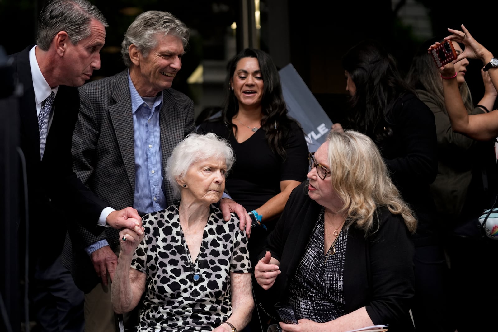 Kitty Menendez' sister, Joan Andersen Vandermolen, bottom left, and niece Karen Vandermolen, right, sit together during a press conference to announce developments on the case of brothers Erik and Lyle Menendez, Wednesday, Oct. 16, 2024, in Los Angeles. (AP Photo/Damian Dovarganes)