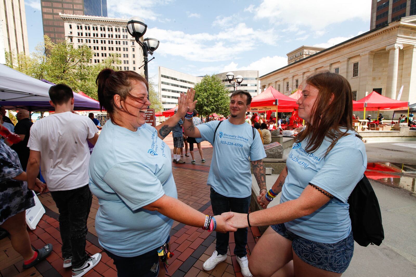 Elizabeth Short of Middletown, left,  her daughter Jordan Short, right, also of Middletown, and Jordan’s boyfriend Robbie Hobbs of Dayton attended the Rally 4 Recovery for the first time on Sunday at Courthouse Square in downtown Dayton. CHRIS STEWART / STAFF