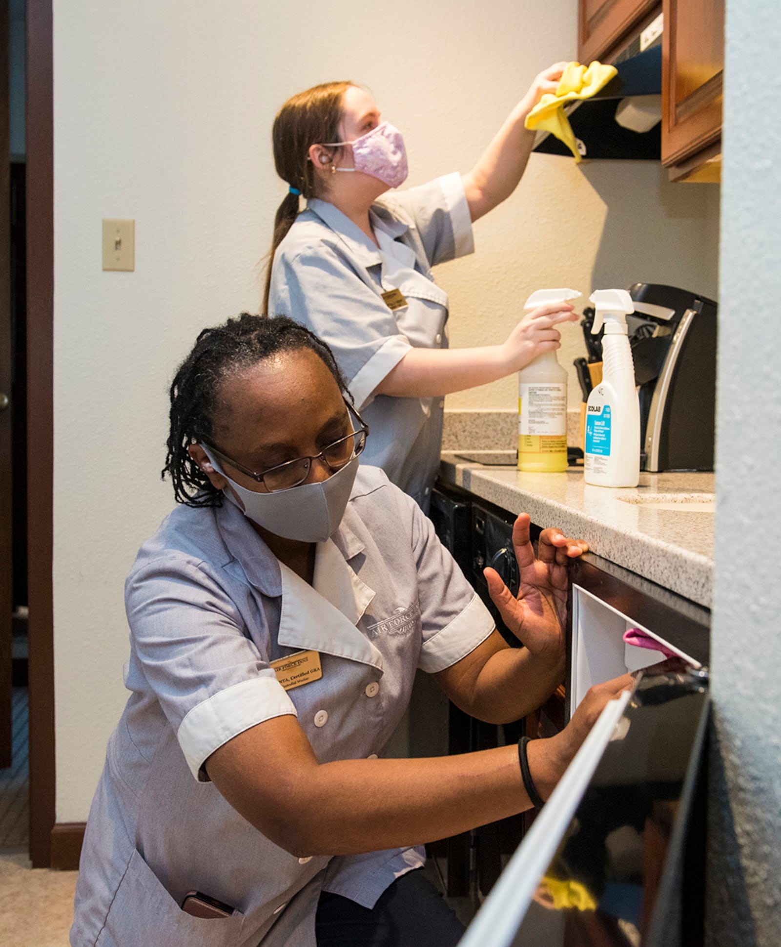 Housekeepers Jacinta Dunbar (left) and Breann Moorman clean a guestroom kitchen at Wright-Patterson Inns on Wright-Patterson Air Force Base on Nov. 5. The inn won the 2021 Air Force Innkeeper Award for a large base. U.S. AIR FORCE PHOTO/JAIMA FOGG