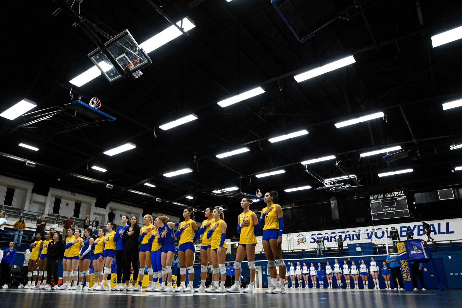 The San Jose State Spartans and Air Force Falcons stand for the National Anthem before an NCAA college volleyball match Thursday, Oct. 31, 2024, in San Jose, Calif. (AP Photo/Eakin Howard)