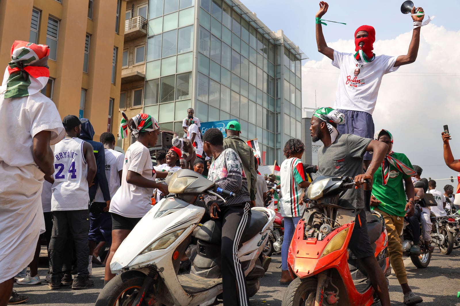 Supporters of opposition candidate and former President John Dramani Mahama celebrate his victory after his opponent Ghana's vice president and ruling party candidate, Mahamudu Bawumia conceded his defeat in Accra, Ghana, Sunday, Dec. 8, 2024. (AP Photo/Misper Apawu)