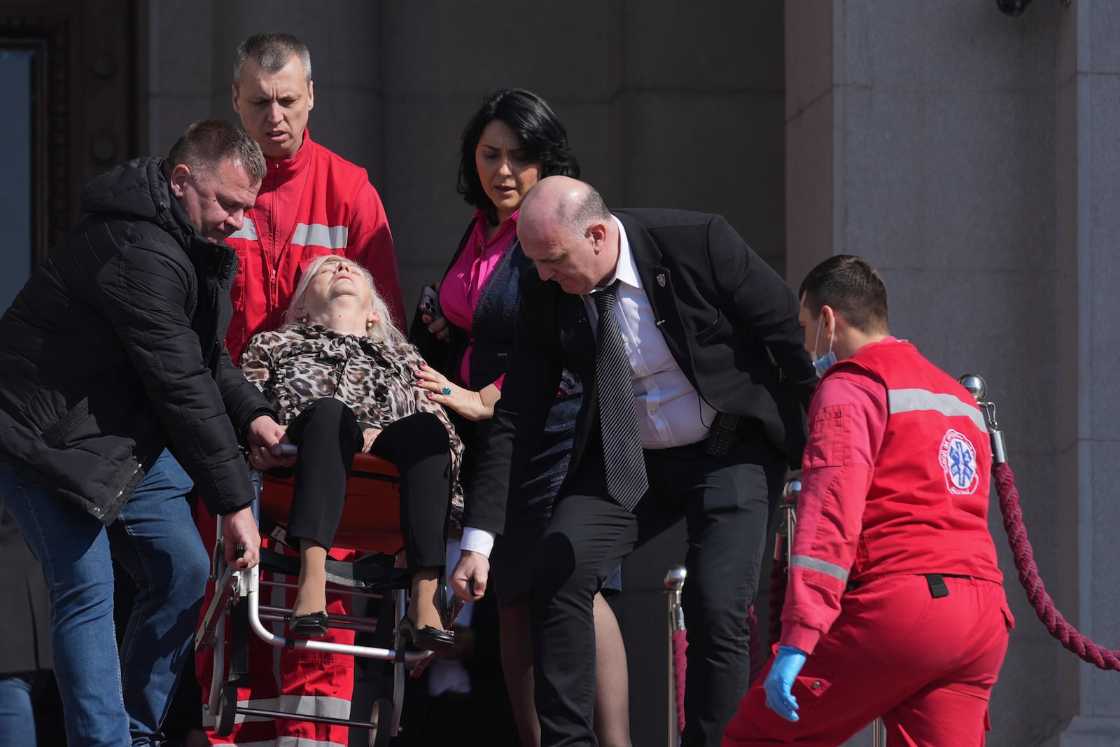 Medics carry a lawmaker injured after chaos erupted during a Serbia's parliament session in Belgrade, Serbia, Tuesday, March 4, 2025. (AP Photo/Darko Vojinovic)