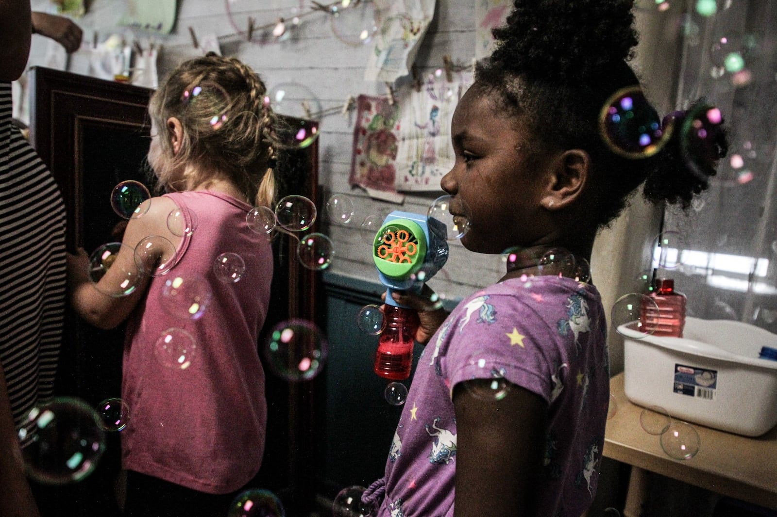 Rainbow Years Child Care Center student, Na'kyha Adams makes bubbles in her classroom .The senate budget proposal would eliminate funding for a child-care quality program. JIM NOELKER/STAFF