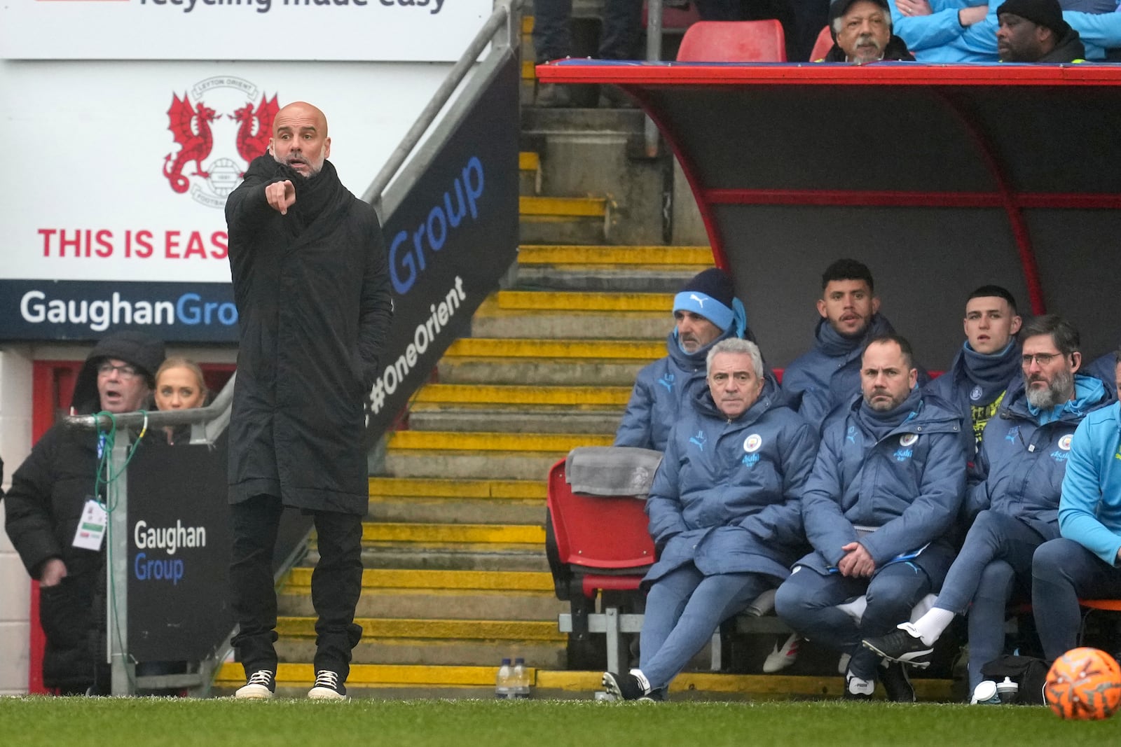 Manchester City's head coach Pep Guardiola, left, gives instructions from the side line during the English FA Cup fourth round soccer match between Leyton Orient and Manchester City at the Gaughan Group Stadium in London, England, Saturday, Feb. 8, 2025. (AP Photo/Kin Cheung)