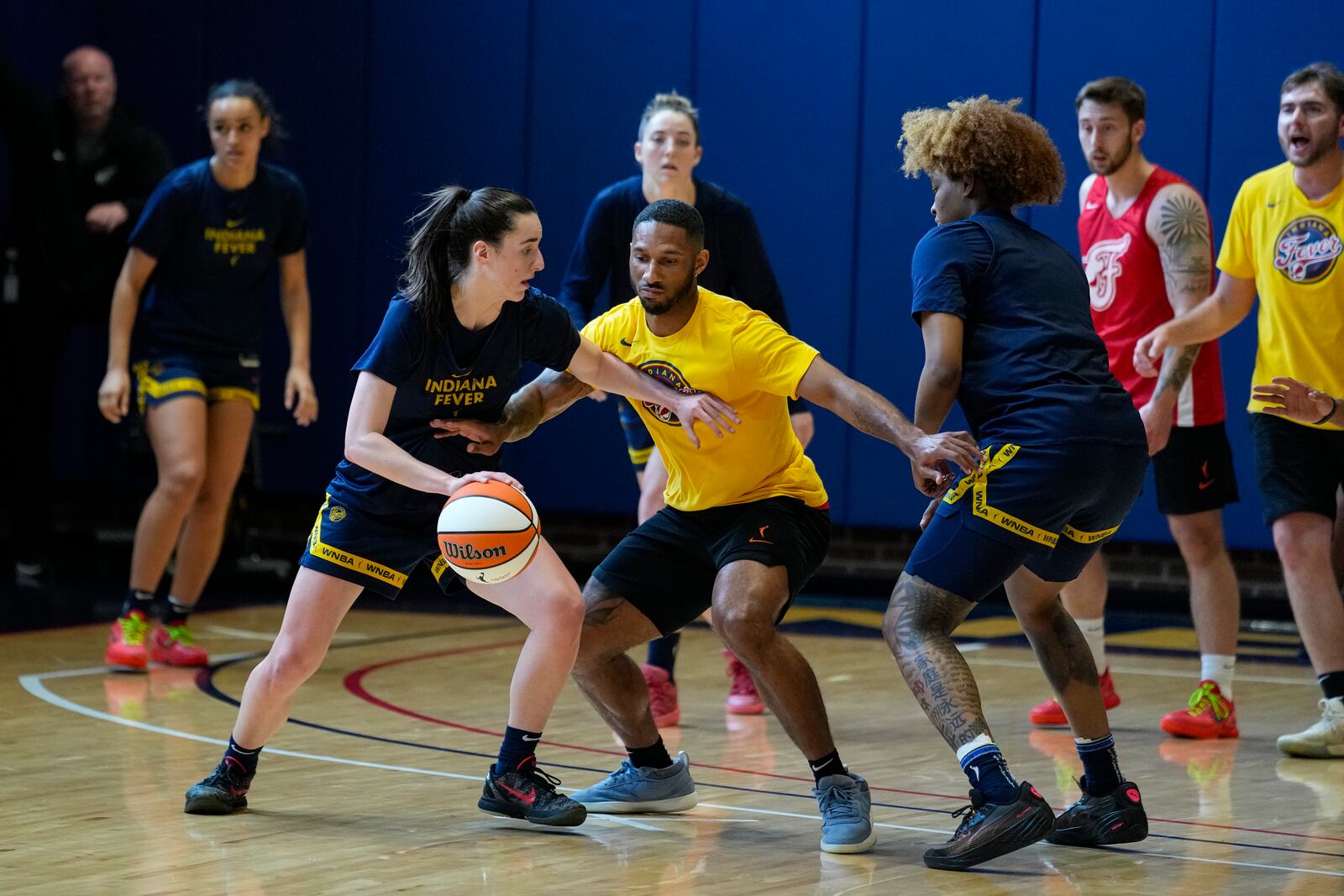 FILE - Indiana Fever guard Caitlin Clark, front left, makes a play against the practice squad as the WNBA basketball team works out in Indianapolis, Sunday, April 28, 2024. (AP Photo/Michael Conroy, File)