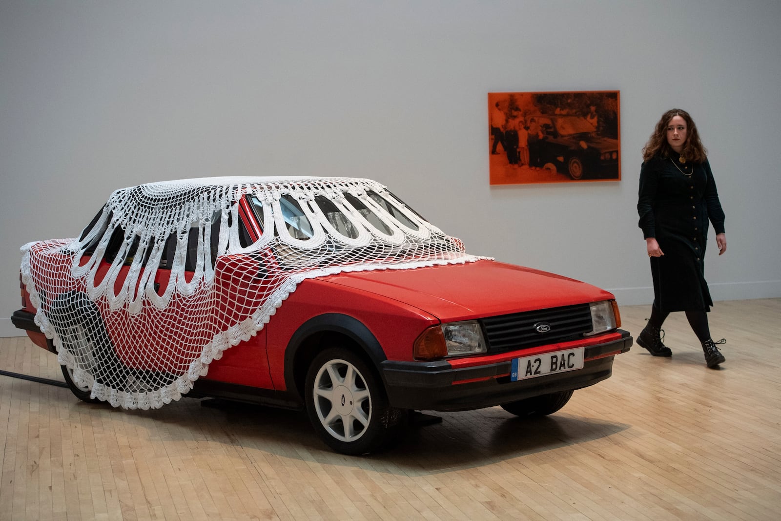 FILE - A woman walks past an artwork by Jasleen Kaur during the Turner Prize 2024 press preview at Tate Britain in London, Tuesday, Sept. 24, 2024. (AP Photo/Thomas Krych, File)