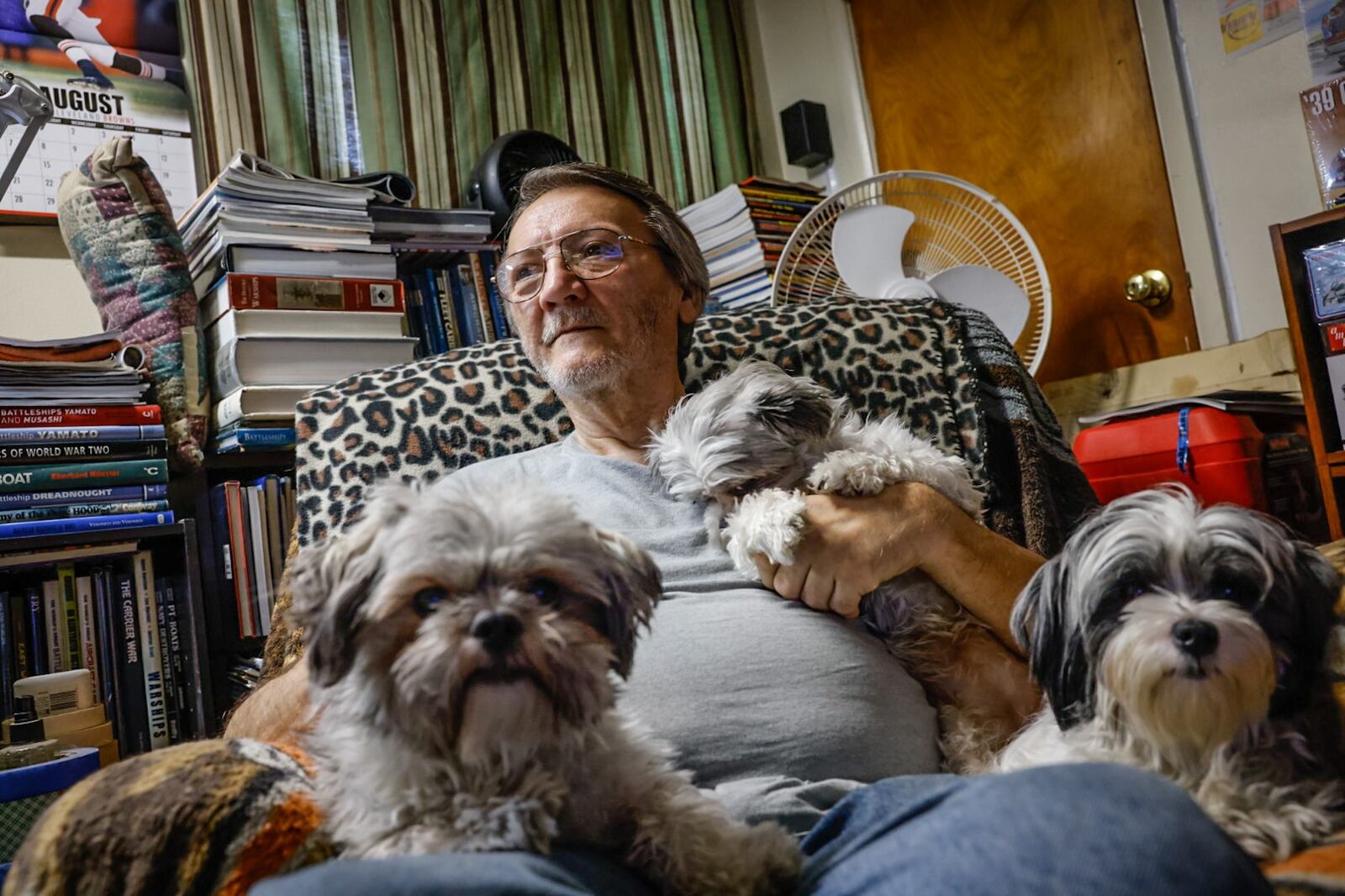 Joseph F. Applegate sits in his favorite chair, in his Favorite room with his Shih tzus in his north Dayton home.  Applegate made the mortgage payments every month, but his deceased wife's name was on the deed which is causing a dispute with Medicaid. JIM NOELKER/STAFF