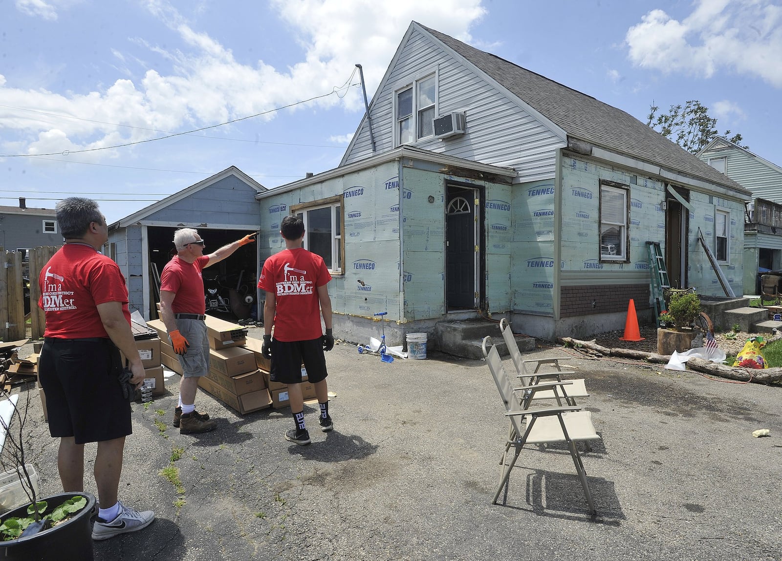 Members of the Southern Ohio District Brethren Disaster Ministries, are working on a home on Loretta Drive in Harrison Township as part of the tornado recovery program. MARSHALL GORBYSTAFF