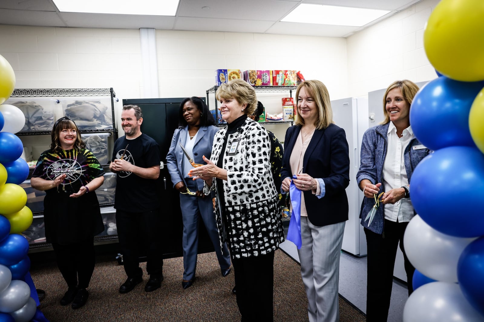 From the right, Molly Lunne, Liz Swanson, Elizabeth Lolli, Wyetta Hayden and Dr. Terress Monroe cut the ribbon on a new food pantry at Edison Elementary School on Broadway St. Wednesday 18, 2022. Dayton Public Schools in partnership with the Foodbank, Miami Valley Meals, Hall Hunger Initiative, Five Rivers Metroparks and the YMCA helped initiate the food pantry. JIM NOELKER/STAFF