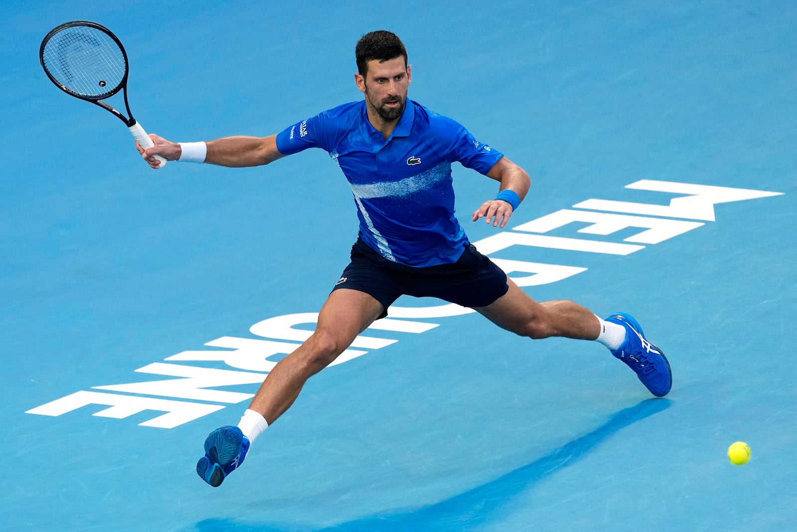 Novak Djokovic of Serbia plays a forehand return to Nishesh Basavareddy of the U.S. during their first round match at the Australian Open tennis championship in Melbourne, Australia, Monday, Jan. 13, 2025. (AP Photo/Asanka Brendon Ratnayake)