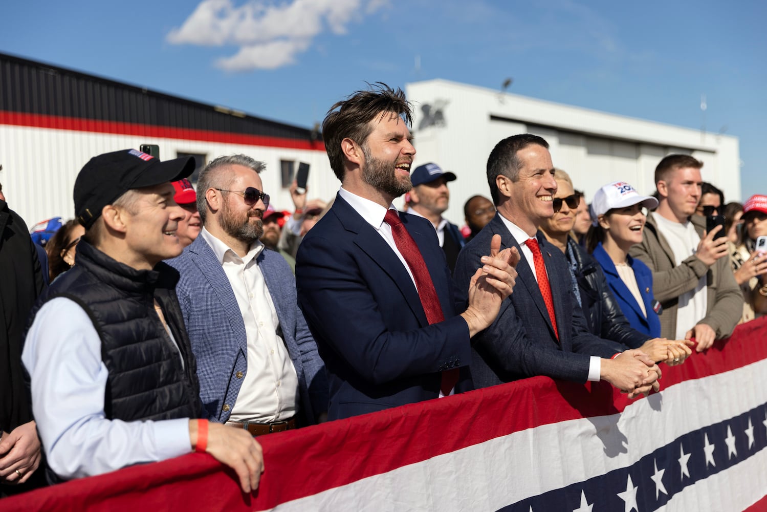 Sen. J.D. Vance (R-Ohio), center, applauds as former President Donald Trump speaks at a campaign rally in Dayton, Ohio, on March 16, 2024. (Maddie McGarvey/The New York Times)