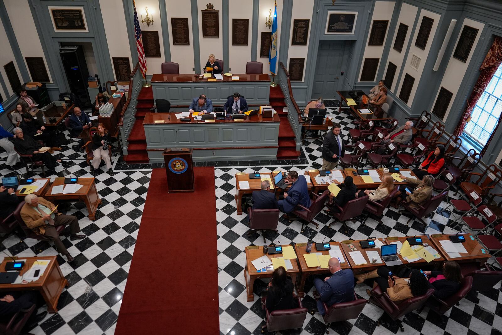 U.S.-Rep.-elect Sarah McBride, D-Del., lower right corner, at her desk on the Senate floor during a special session, her last day as a Delaware state senator, at the Delaware Legislative Hall in Dover, Del., Monday, Dec. 16, 2024. (AP Photo/Carolyn Kaster)