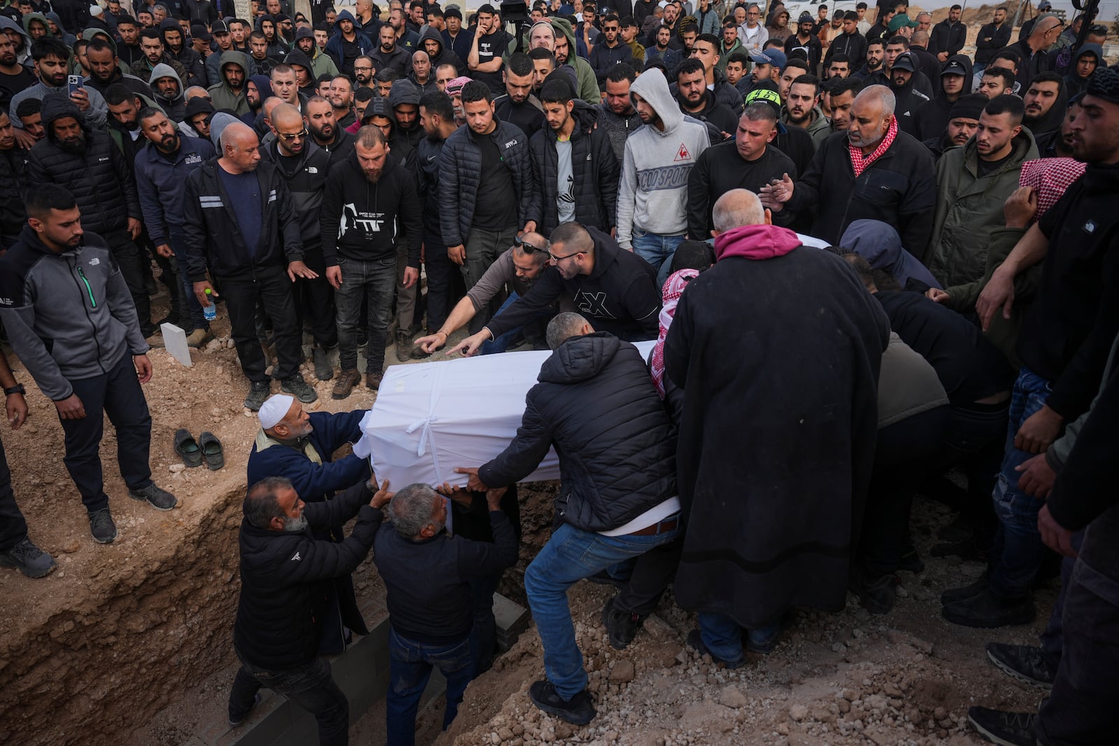 Mourners carry the body of 23-year-old hostage Hamzah AlZayadni, during his funeral in the Bedouin city of Rahat, southern Israel, Friday, Jan. 10, 2025. AlZayadni was in Hamas captivity in the Gaza Strip. Israel's army said his body was recovered in an underground tunnel in southern Gaza. (AP Photo/Ariel Schalit)