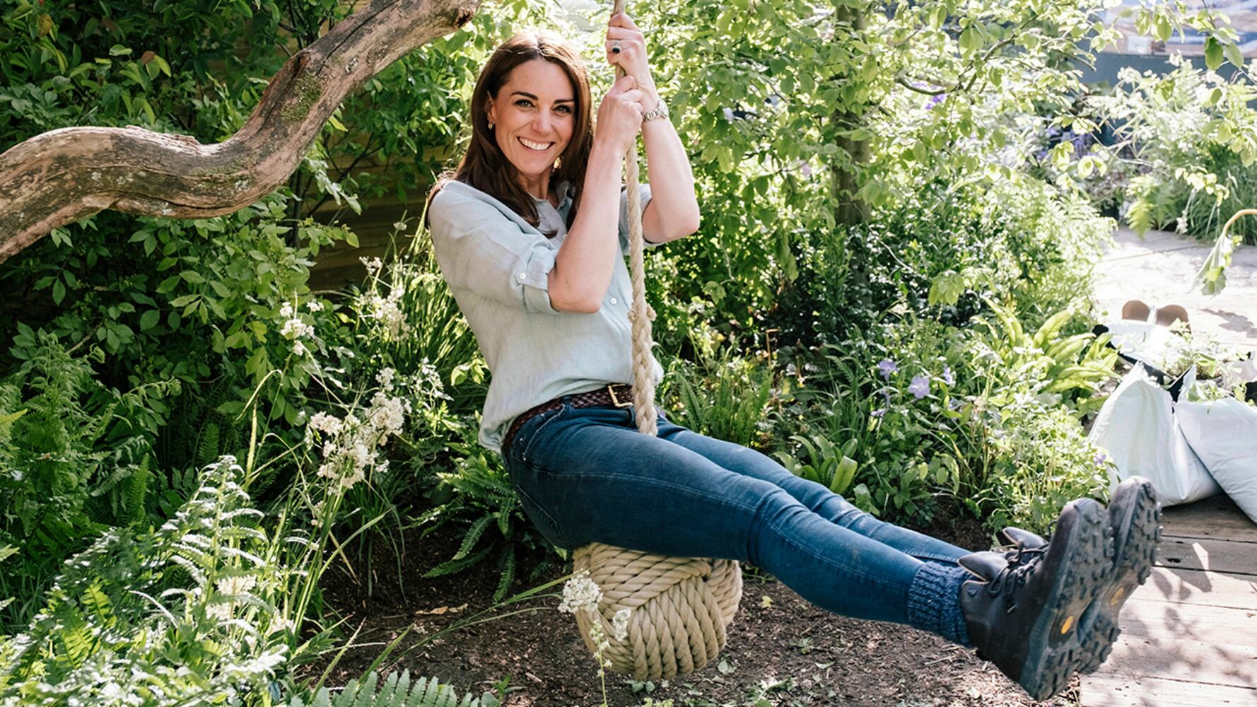 In this image made available on Sunday May 19, 2019 by Kensington Palace, Britain's Kate, Duchess of Cambridge and her son Prince Louis play in the ‘Bback to Nature’ garden at the RHS Chelsea Flower Show in London