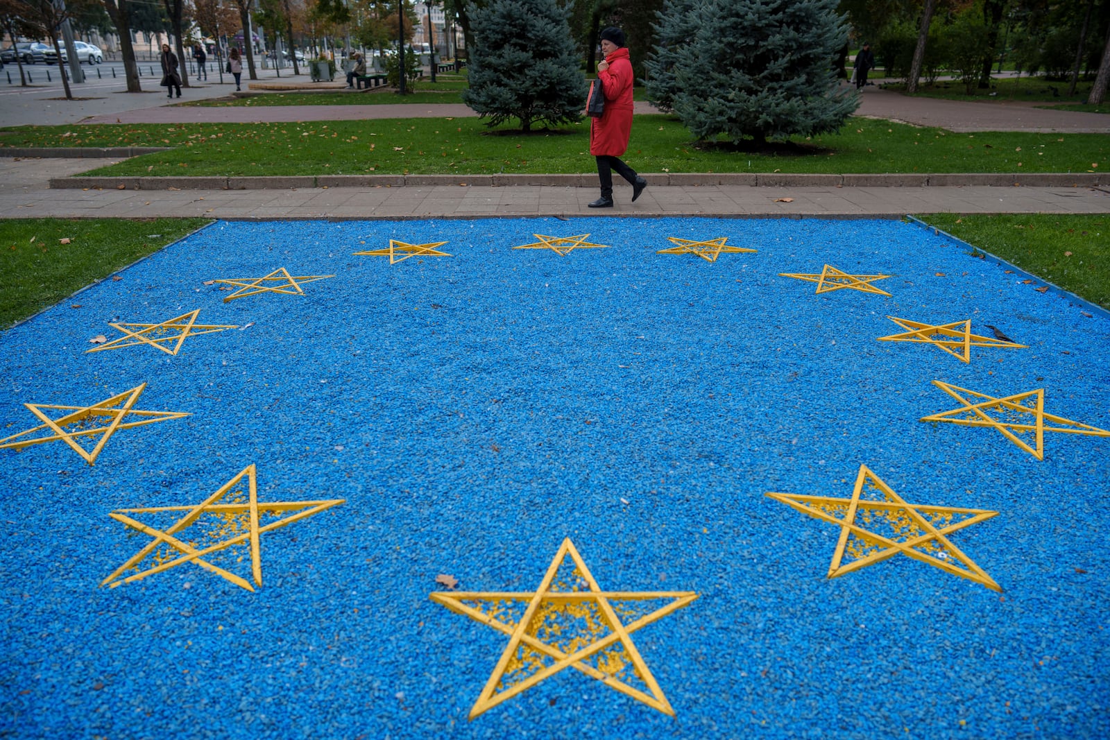 FILE - A woman walks by a depiction of the European Union flag near a park in central Chisinau, Moldova, Oct. 17, 2024. (AP Photo/Vadim Ghirda, File)