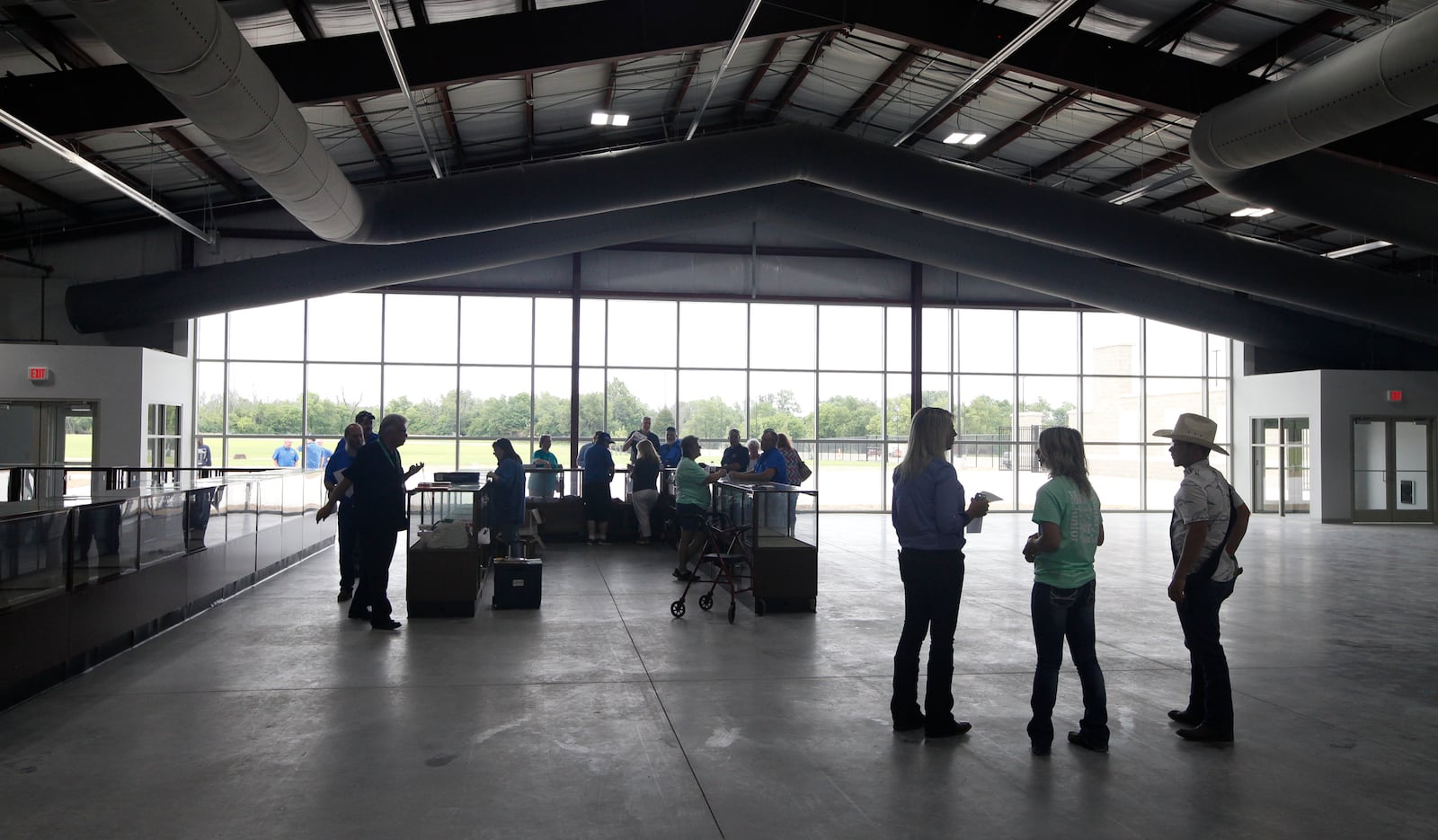 People gather Monday in the climate-controlled 26,000-square-foot main event building at the new Montgomery County Fairgrounds & Expo Center in Jefferson Twp. CHRIS STEWART / STAFF