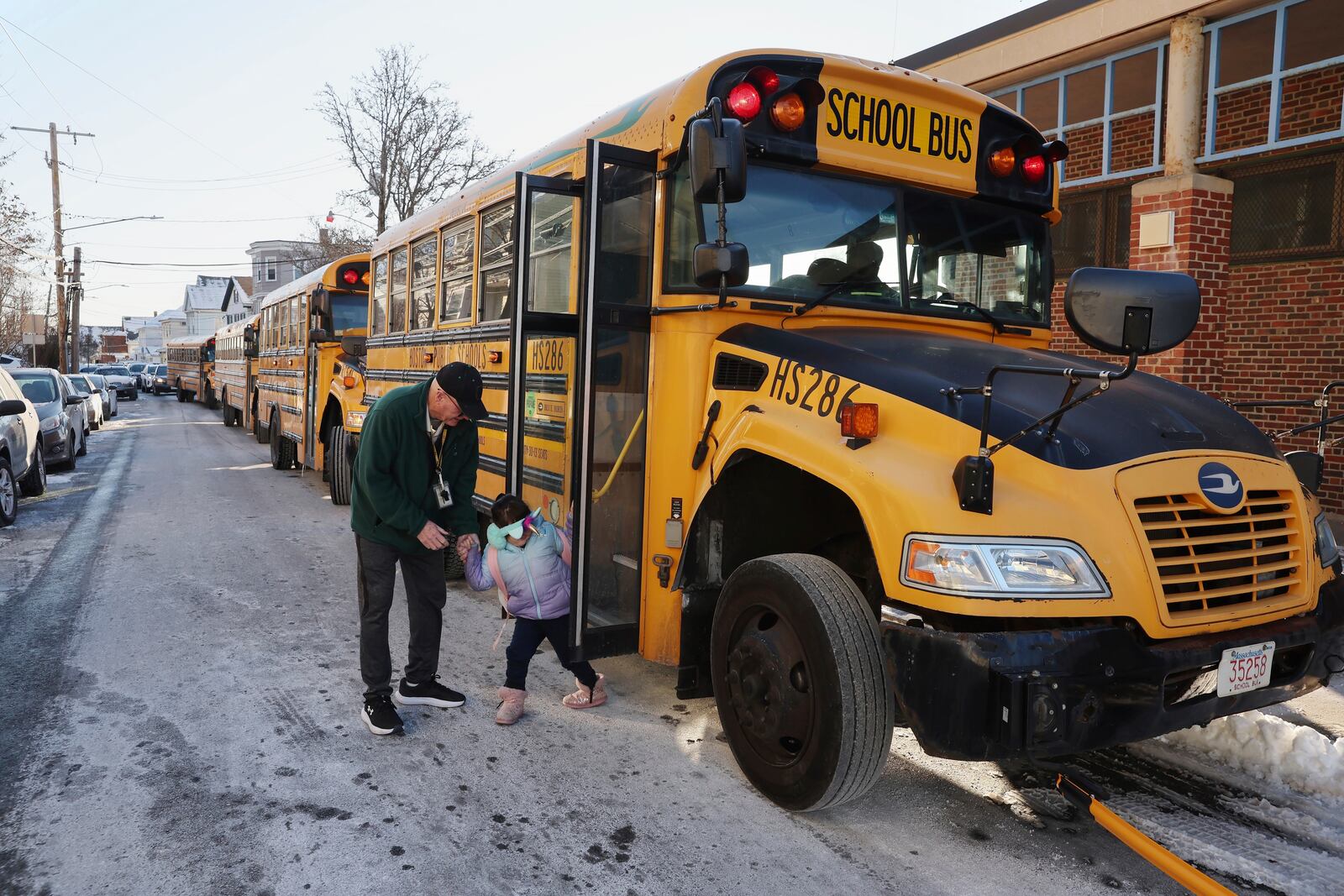 A student arrives for school Tuesday, Jan. 21, 2025, in the East Boston neighborhood of Boston. (AP Photo/Michael Dwyer)