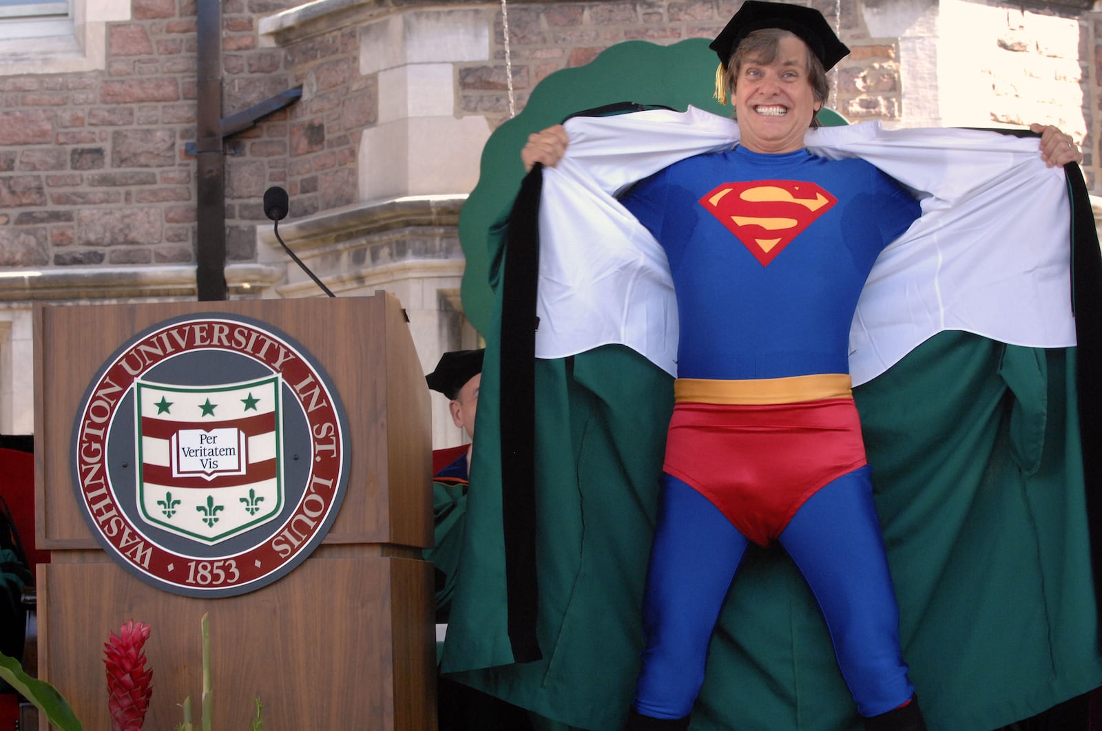 Editorial cartoonist Mike Peters delivers the commencement address and receives an honorary degree from Washington University in St. Louis.
He graduated from the school in 1965

He ended his speech by ripping open his robe and revealing a Superman costume.

Photos provided by Washington University.