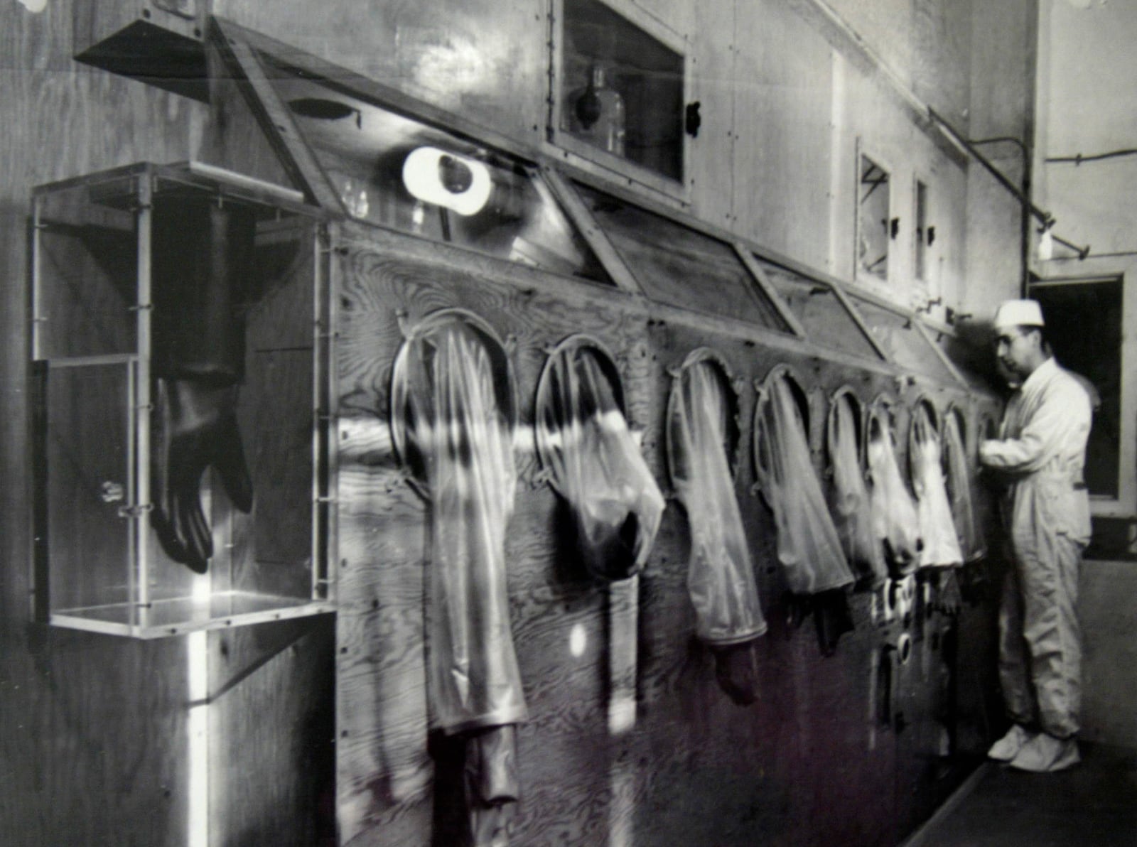 The Mound Museum in Miamisburg houses technology, worker information and photographs of its' history including this photograph taken in 1946 of a worker on the first glove box line processing polonium.  Photo from the Mound Museum archive