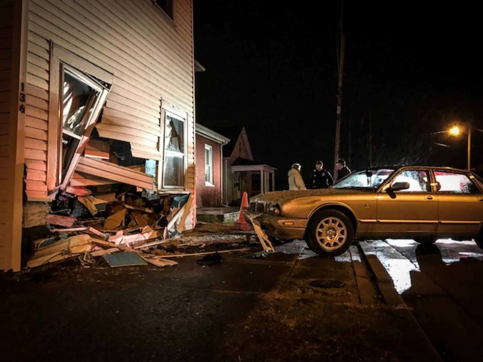 Four teenagers were in this car that smashed into a house Monday night on East Main Street in Piqua. None of the teems was injured, police said. (Jim Noelker/Staff)