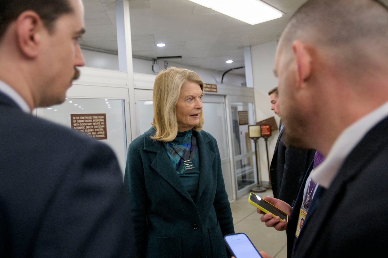 Sen. Lisa Murkowski, R-Alaska, talks with reporters as she makes her way through the Senate subway at the Capitol, Thursday, Jan. 23, 2025, in Washington. (AP Photo/Rod Lamkey, Jr.)