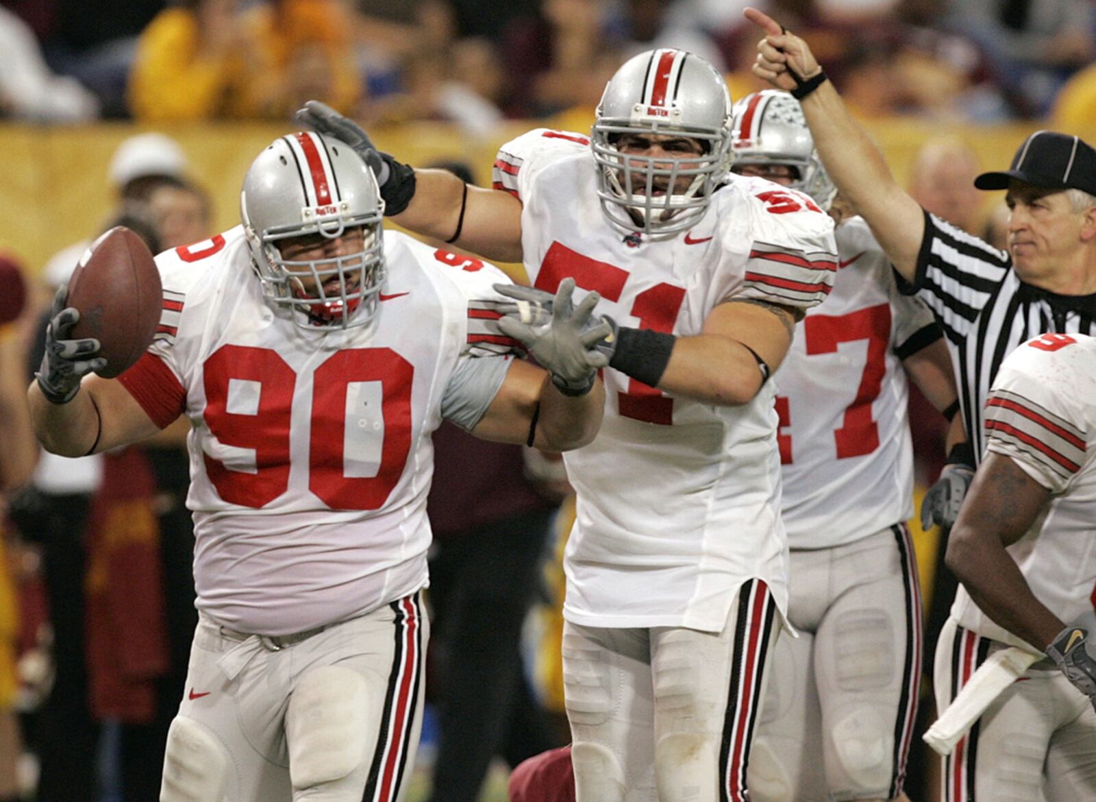 Ohio State linebacker Antony Schlegel 951) congratulates defensive tackle Quinn Pitcock (90) after Pitcock recovered a fumble by Minnesota tailback Laurence Maroney during the fourth quarter in Minneapolis, Saturday, Oct. 29, 2005. Ohio State beat Minnesota 45-31. (AP Photo/Ann Heisenfelt)