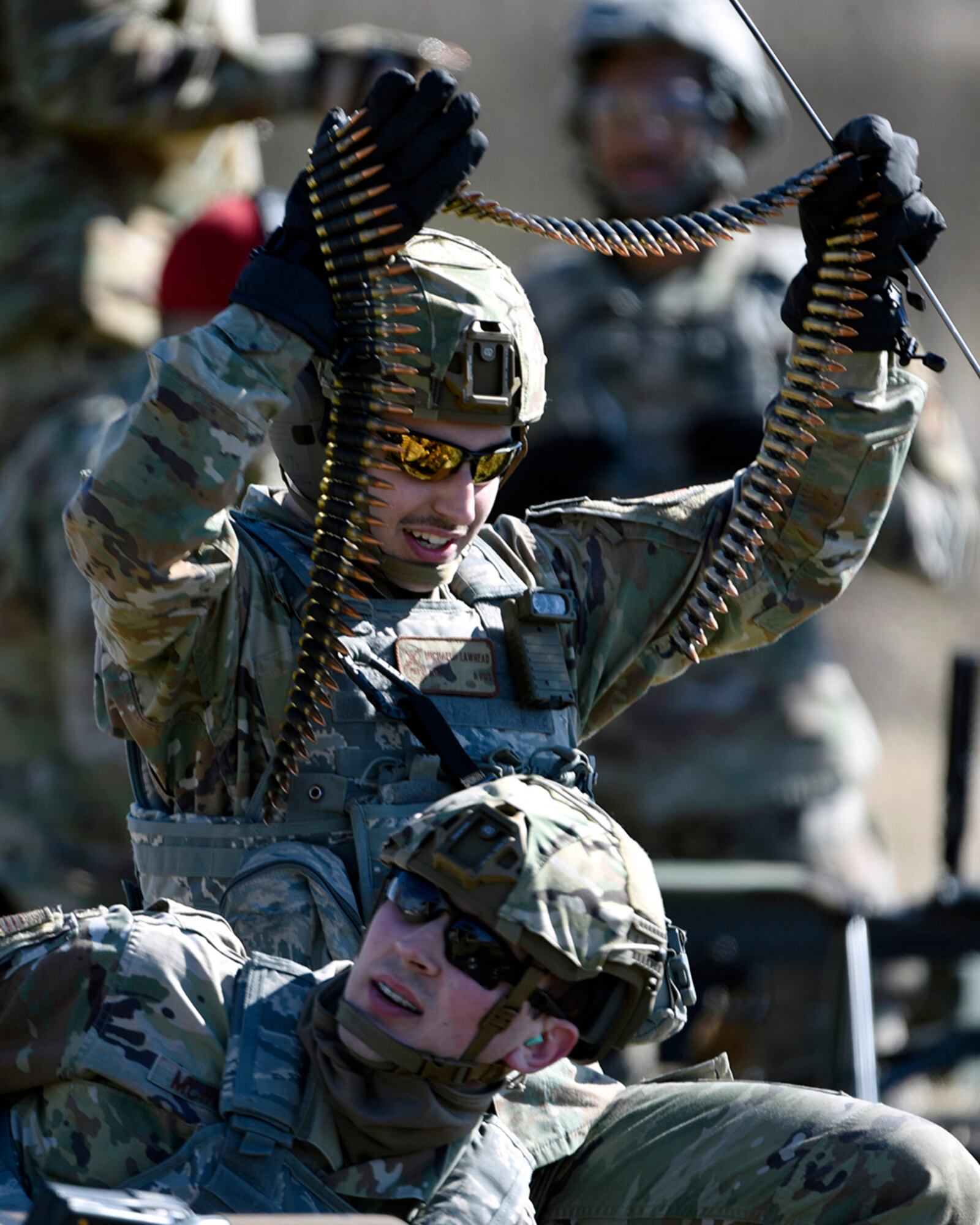 Airman 1st Class Michael Lawhead, an 88th Security Forces Squadron alarm monitor, prepares to load an M240B machine gun with Staff Sgt. Sawyer McIntyre, an 88 SFS combat-arms instructor, at Camp Atterbury, Indiana, on Feb. 25. U.S. AIR FORCE PHOTO/TY GREENLEES