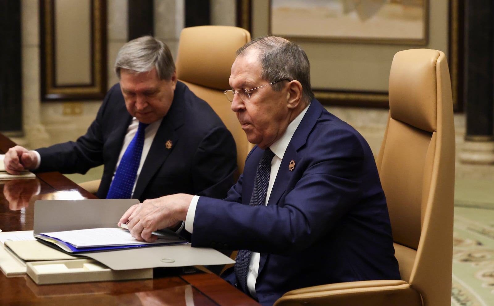 Russian Foreign Minister Sergei Lavrov, right, sits next to Russian President Vladimir Putin's foreign policy advisor Yuri Ushakov during a meeting with U.S. Secretary of State Marco Rubio, U.S. National Security Advisor Mike Waltz and U.S. Middle East envoy Steve Witkoff, Saudi Foreign Minister Prince Faisal bin Farhan Al Saud and Saudi National Security Advisor Mosaad bin Mohammad Al-Aiban, at Diriyah Palace, in Riyadh, Saudi Arabia, Tuesday, Feb. 18, 2025. (Evelyn Hockstein/Pool Photo via AP)