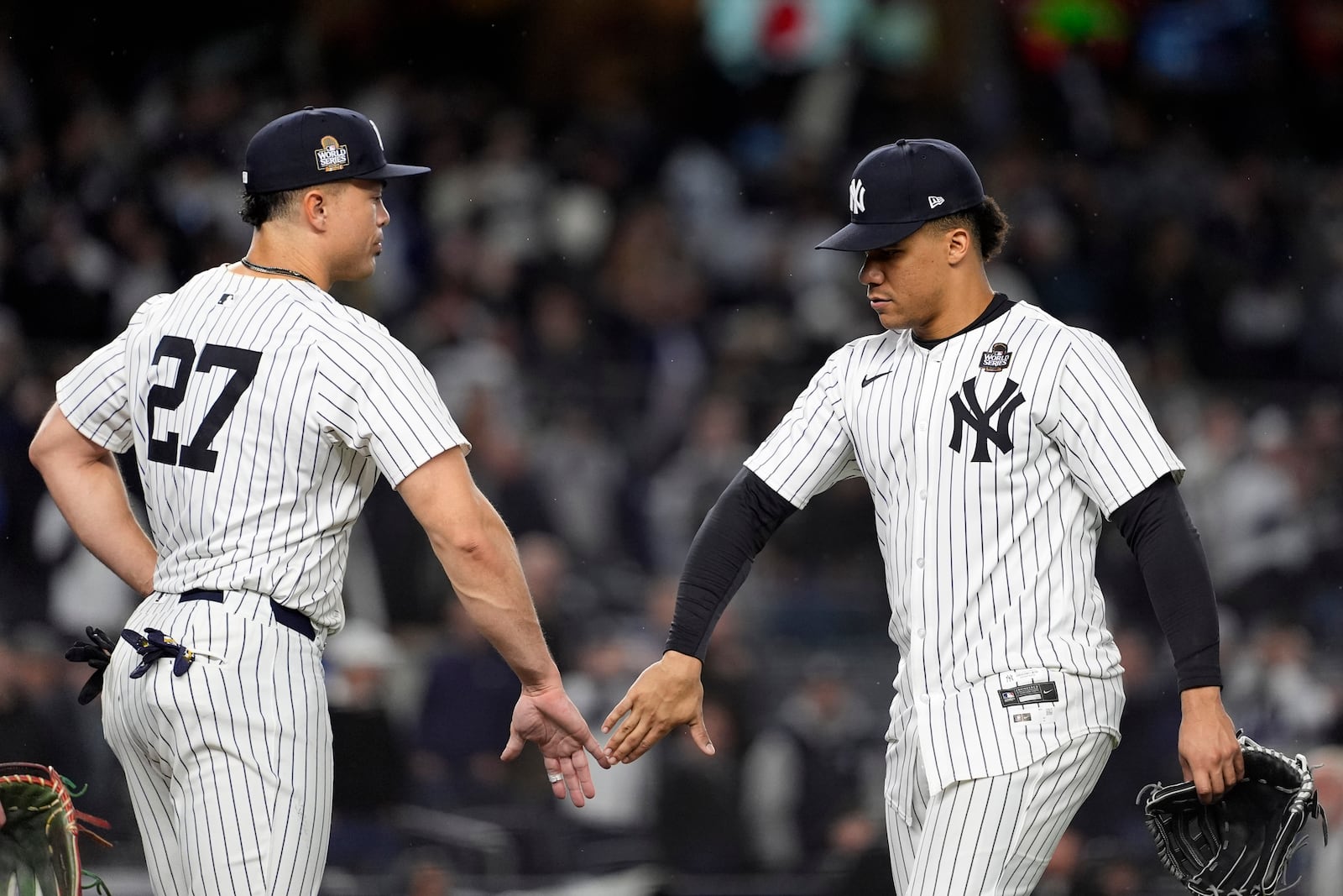 New York Yankees' Giancarlo Stanton (27) and Juan Soto celebrate after Game 4 of the baseball World Series against the Los Angeles Dodgers, Tuesday, Oct. 29, 2024, in New York. The Yankees won 11-4. (AP Photo/Godofredo A. Vásquez)