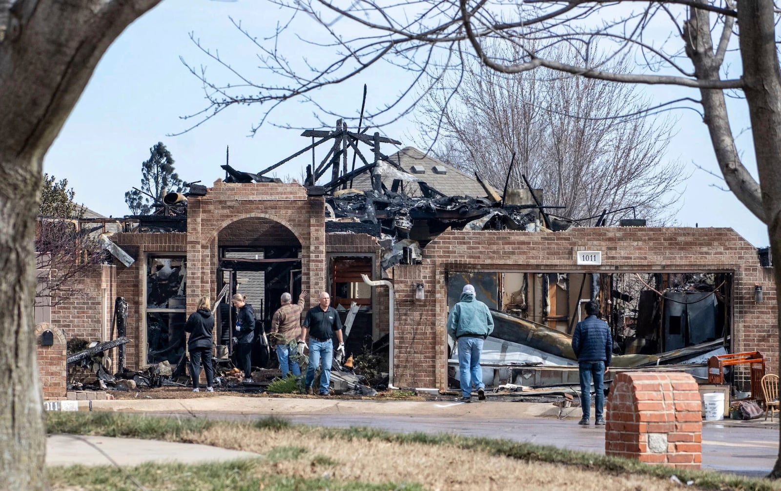 Stillwater, Okla., residents asses the damage in the Crosswinds and Pecan Hill communities due to Friday's wildfires on the west side of town, Saturday, March 15, 2025. (Jason Elmquist/The News Press via AP)