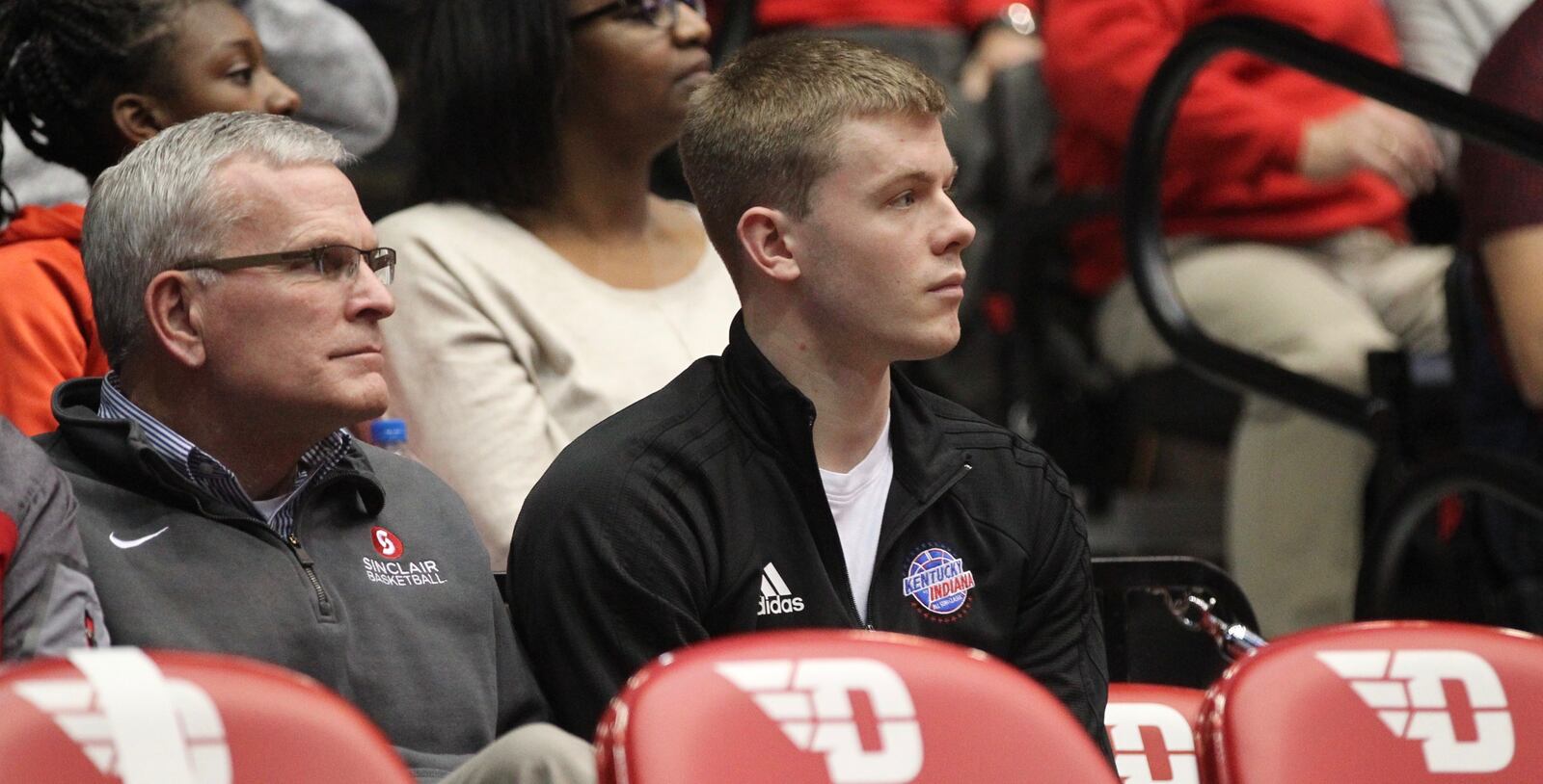 Sean McNeil, center, watches from behind the Dayton bench during a game against Mississippi State on Nov. 30, 2018, at UD Arena.