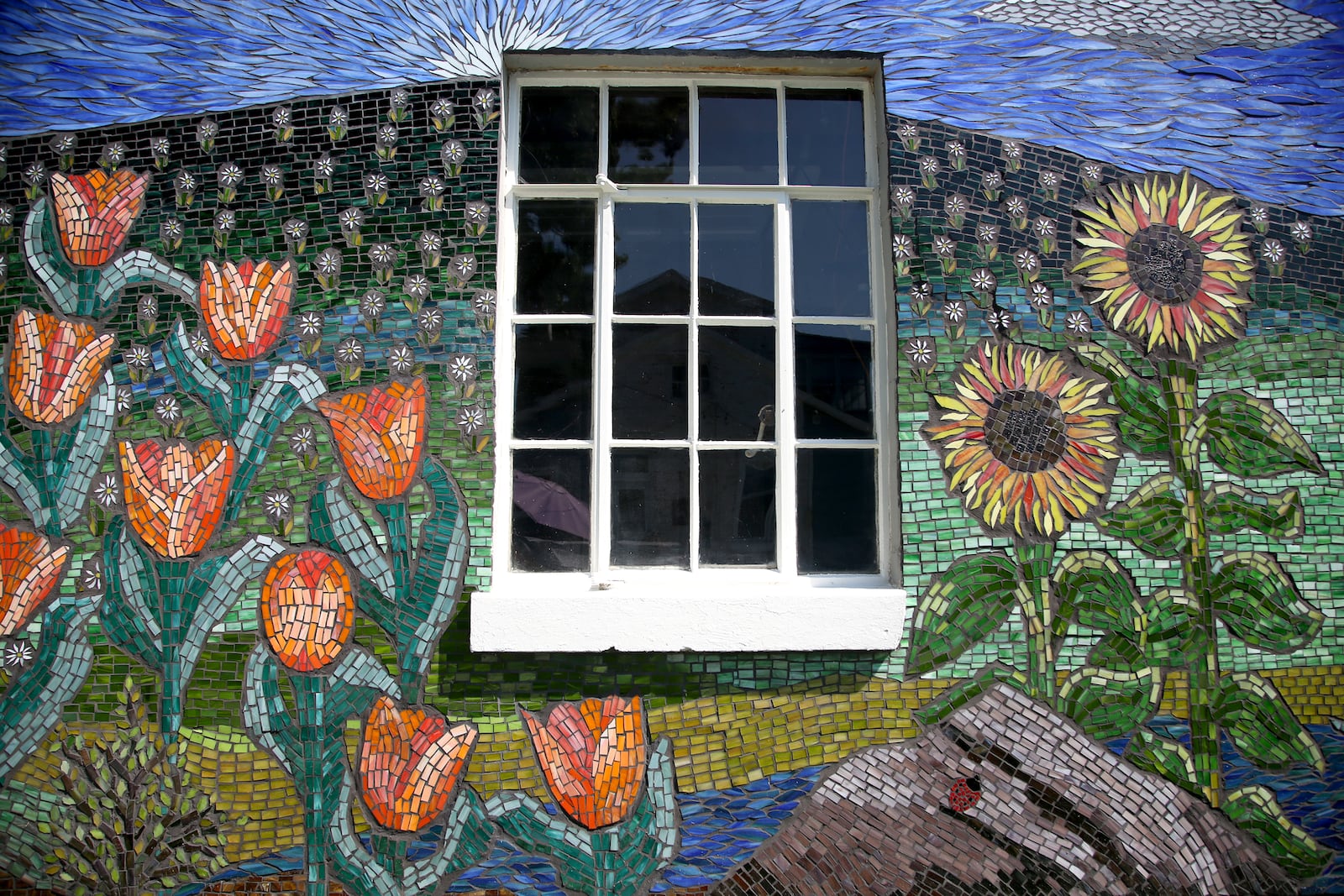 Guustie Alvarado, a Tipp City artist, spent a year creating “Covid Wall,” a glass mosaic on her garage. The artwork is filled with images meaningful to her life experience. Alvarado will be a presenter at PechaKucha Night Dayton on Wednesday, Sept. 1. The event will be held downtown at the Levitt Pavilion and begins at 7:30 p.m. LISA POWELL / STAFF