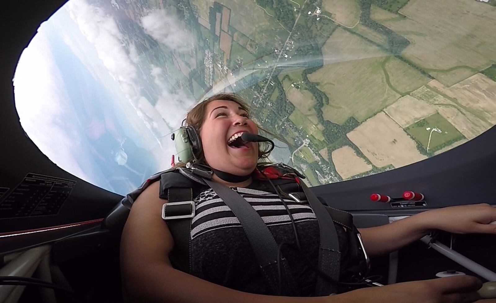 Annie Stemen, 17, from Sidney, smiled and laughed during her entire flight with Sean D. Tucker while flying for the first time in the Young Eagles program run by the Experimental Aircraft Association. Tucker, a National Aviation Hall of Fame inductee, flew Stemen on Thursday before the weekend Vectren Dayton Air Show where he will perform. TY GREENLEES / STAFF