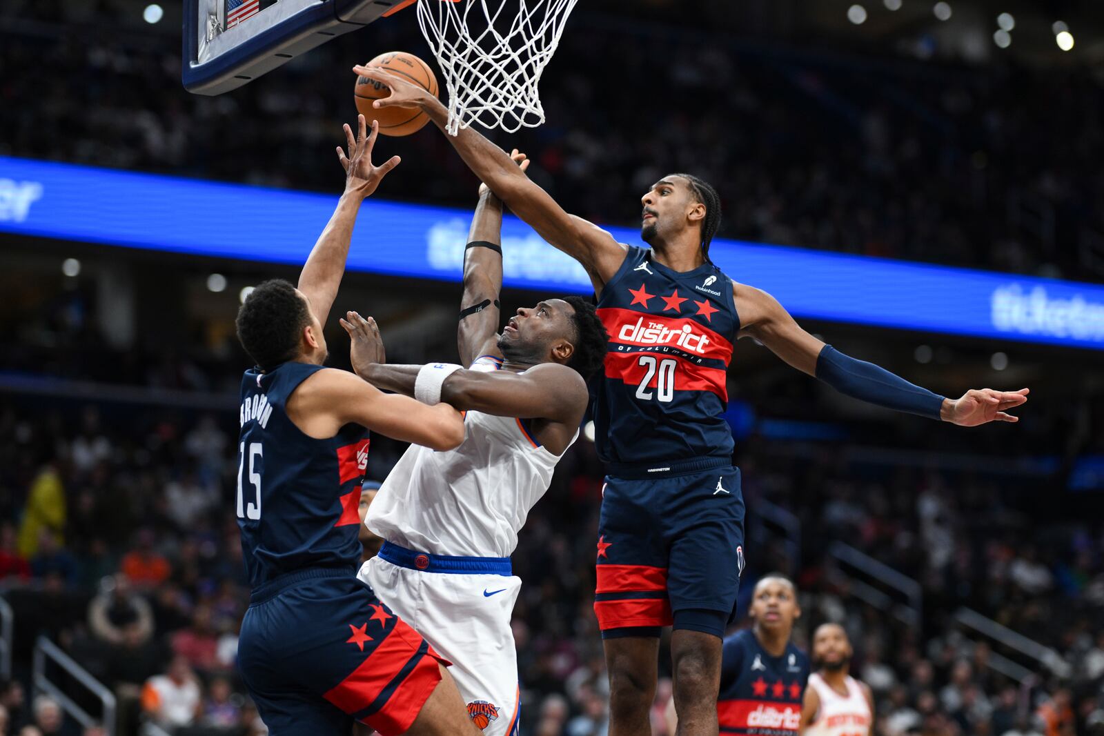 New York Knicks forward OG Anunoby (8) has his shot blocked by Washington Wizards forward Alexandre Sarr (20) during the second half of an NBA basketball game, Saturday, Dec. 28, 2024, in Washington. (AP Photo/Terrance Williams)