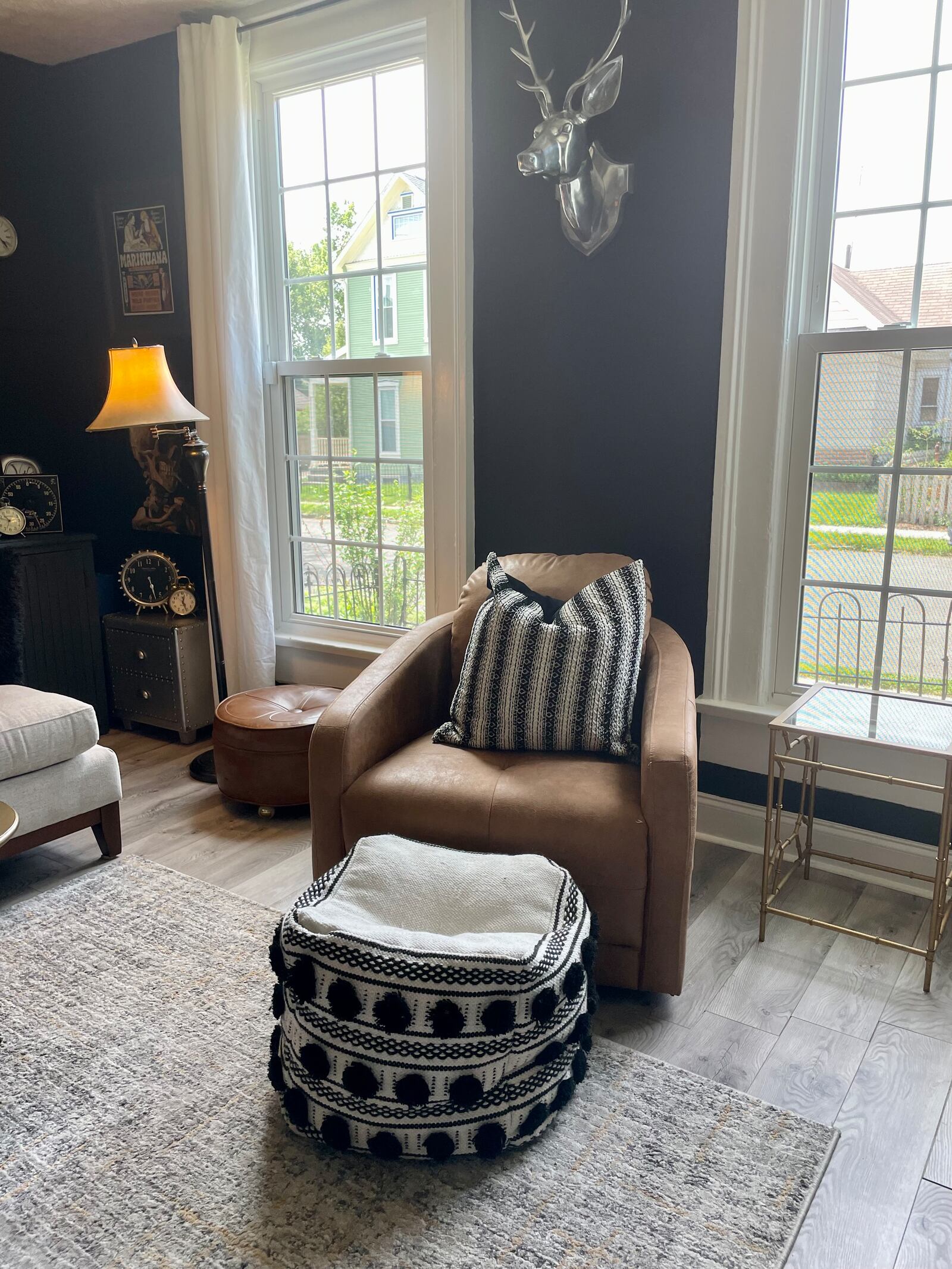 The well-lit living room welcomes guests with a dramatic yet cozy appeal. Photo by Robin McMacken