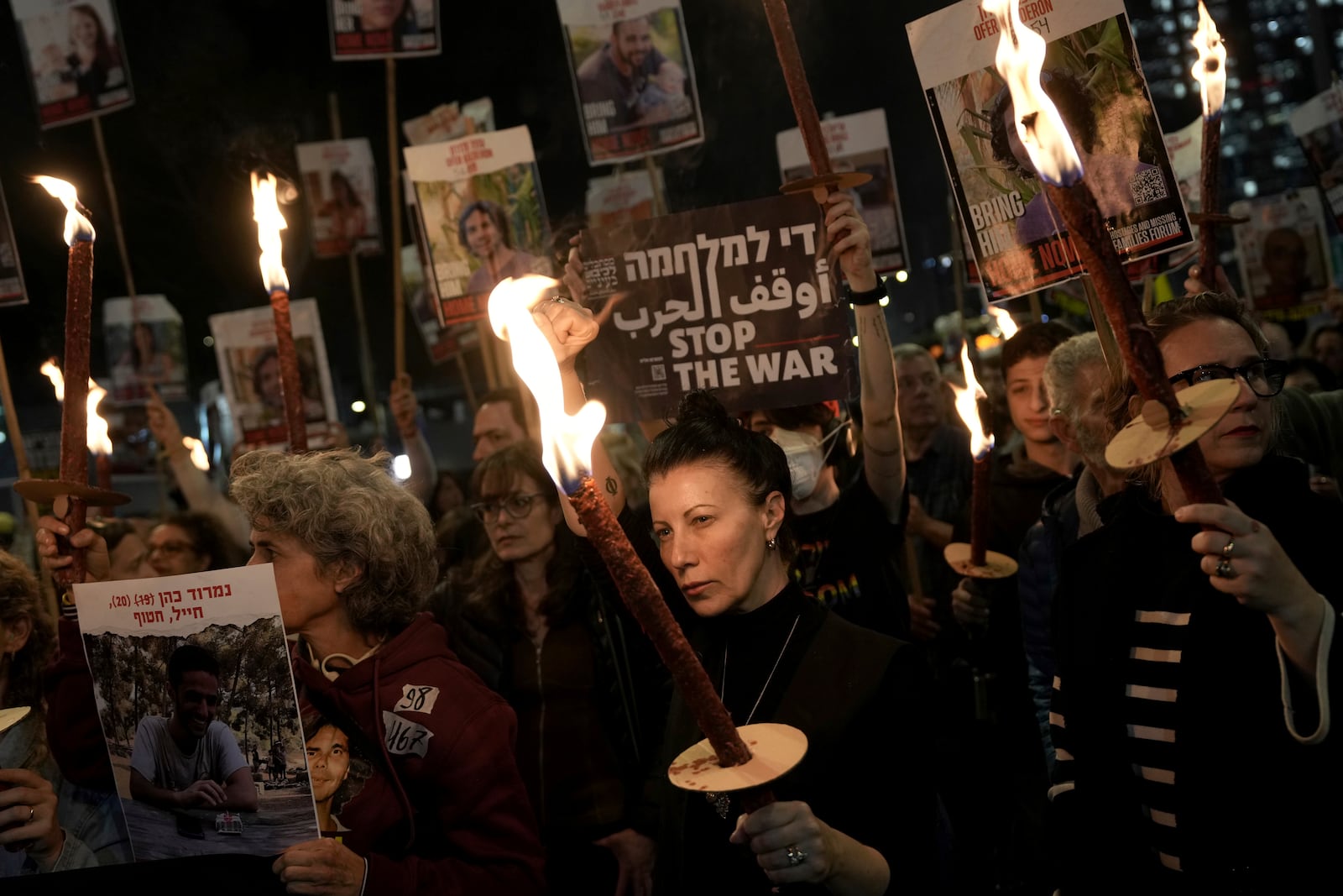 Relatives and friends of people killed and abducted by Hamas and taken into Gaza, react to the ceasefire announcement as they take part in a demonstration in Tel Aviv, Israel, Wednesday, Jan. 15, 2025. (AP Photo/Oded Balilty)