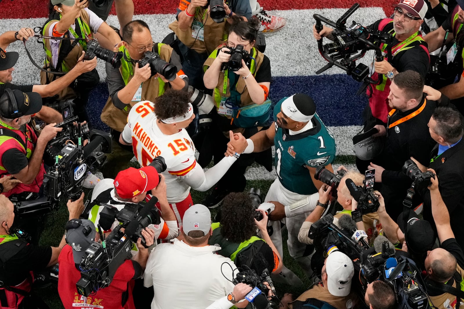 Kansas City Chiefs quarterback Patrick Mahomes (15) and Philadelphia Eagles quarterback Jalen Hurts (1) shake hands after the NFL Super Bowl 59 football game, Sunday, Feb. 9, 2025, in New Orleans. (AP Photo/Godofredo A. Vásquez)