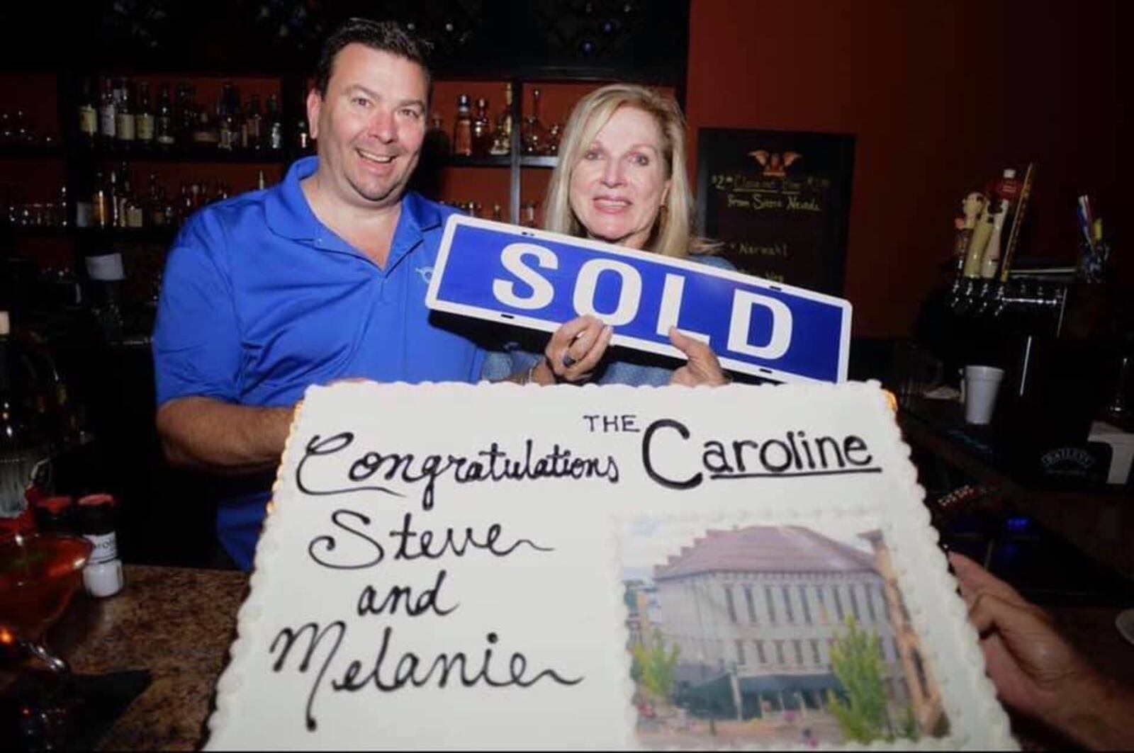 Steve Smith and Melanie Elsass-Smith celebrate the purchase of the Dye Building in downtown Troy.