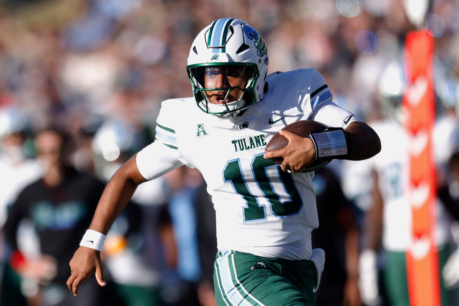 FILE - Tulane quarterback Darian Mensah rushes for s 22 yard gain during the fourth quarter of an NCAA football game against Navy on Nov. 16, 2024, in Annapolis, Md. (AP Photo/Mike Buscher, File)