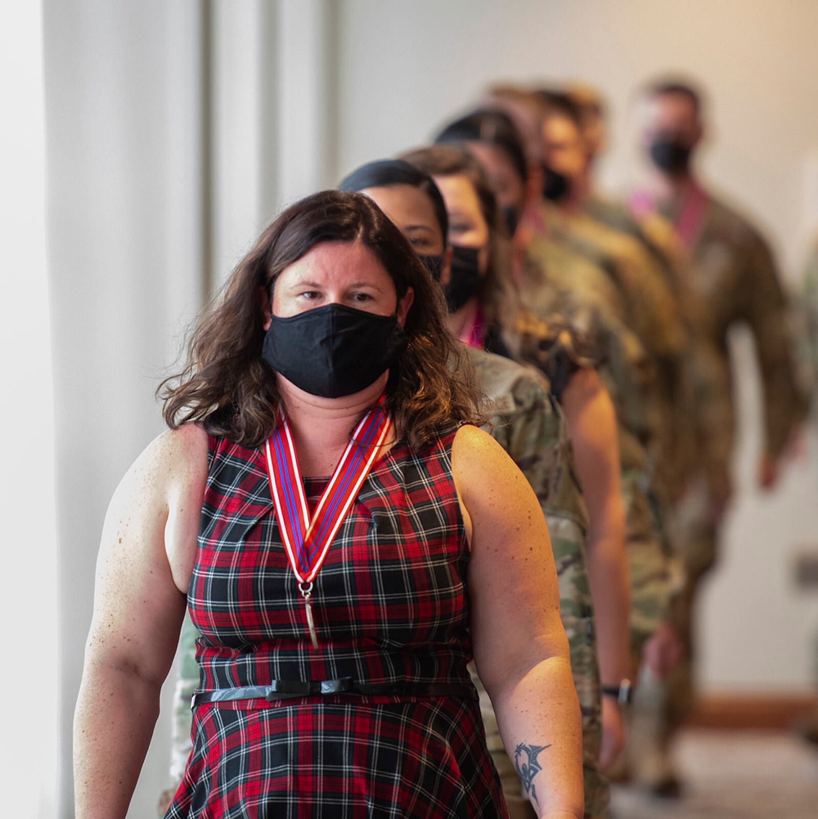 Kathaleen Berhiet, an Air Force Life Cycle Management Center administrative assistant, leads her Airman Leadership School classmates in for their graduation ceremony Oct. 14 at the Wright-Patterson Club. U.S. AIR FORCE PHOTO/R.J. ORIEZ