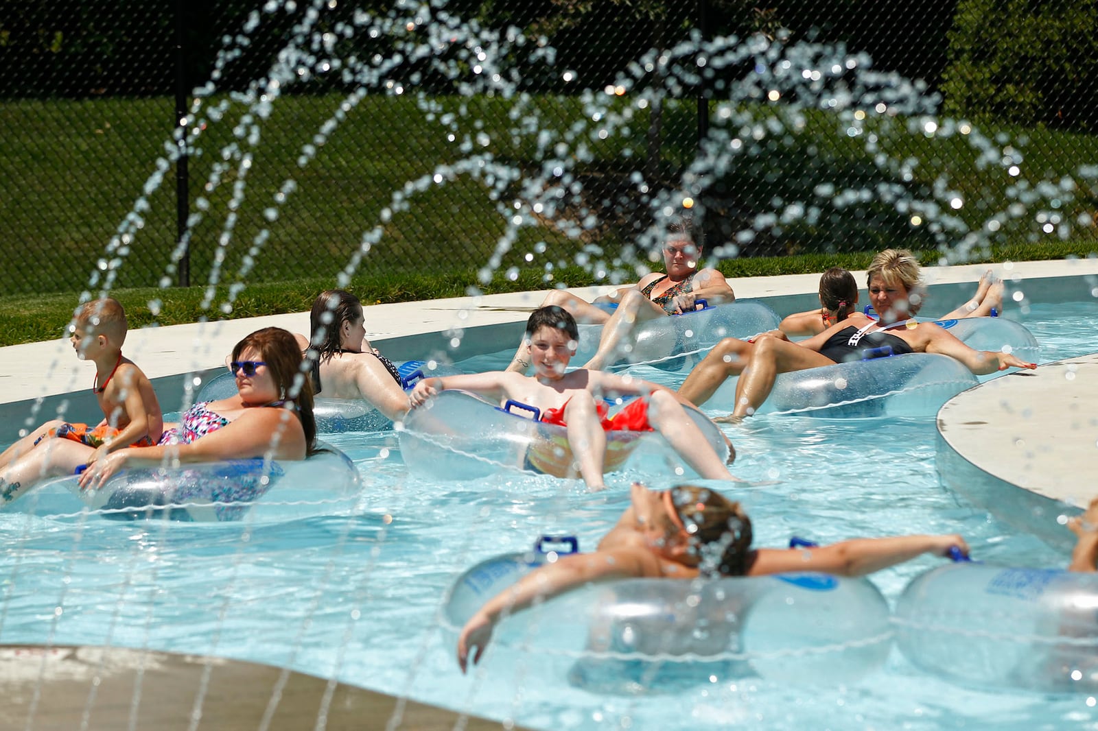 Swimmers at the Kroger Aquatics Center at The Heights float around the Lazy River on a warm Tuesday afternoon.  The parking lot of the water park was almost full by noon.