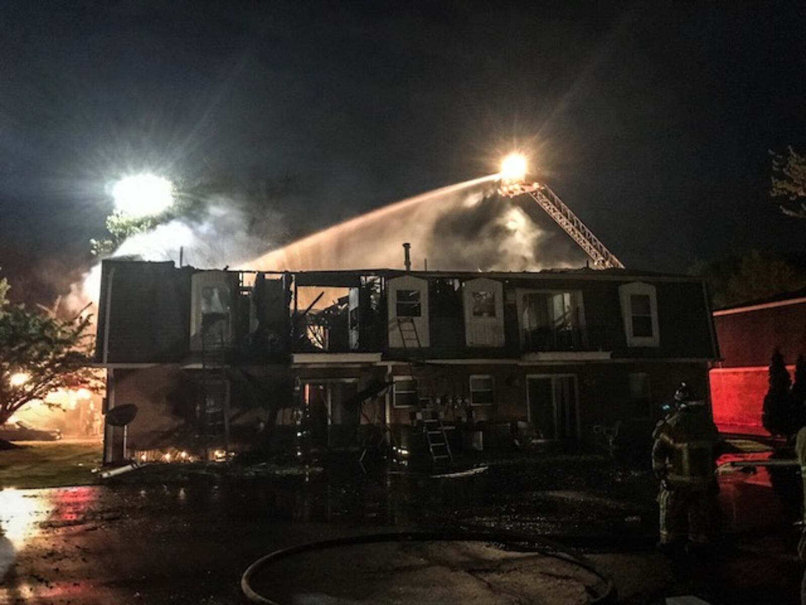 Winds helped to quickly spread flames on the roof of this four-plex apartment building on Stewville Drive in Vandalia on Wednesday night, May 9, 2018, Fire Chief Chad Follick said. (Jim Noelker/Staff)