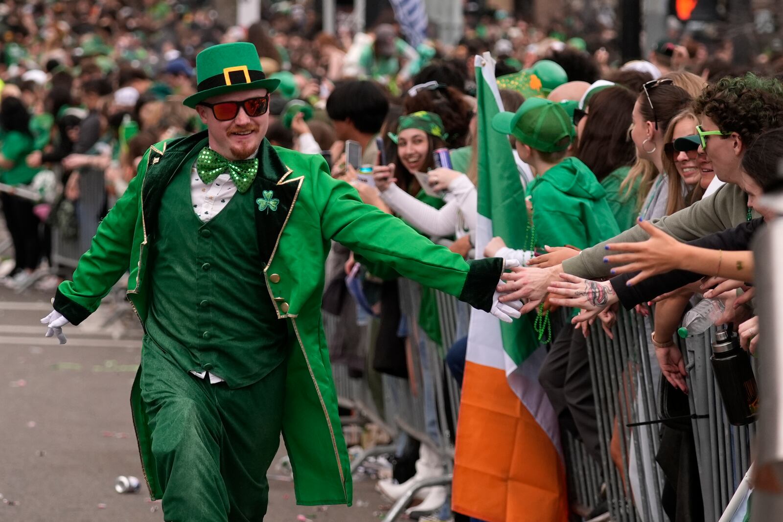 A man dressed as a leprechaun slaps hands with the crowd during the St. Patrick's Day parade, Sunday, March 16, 2025, in Boston, Mass. (AP Photo/Robert F. Bukaty)